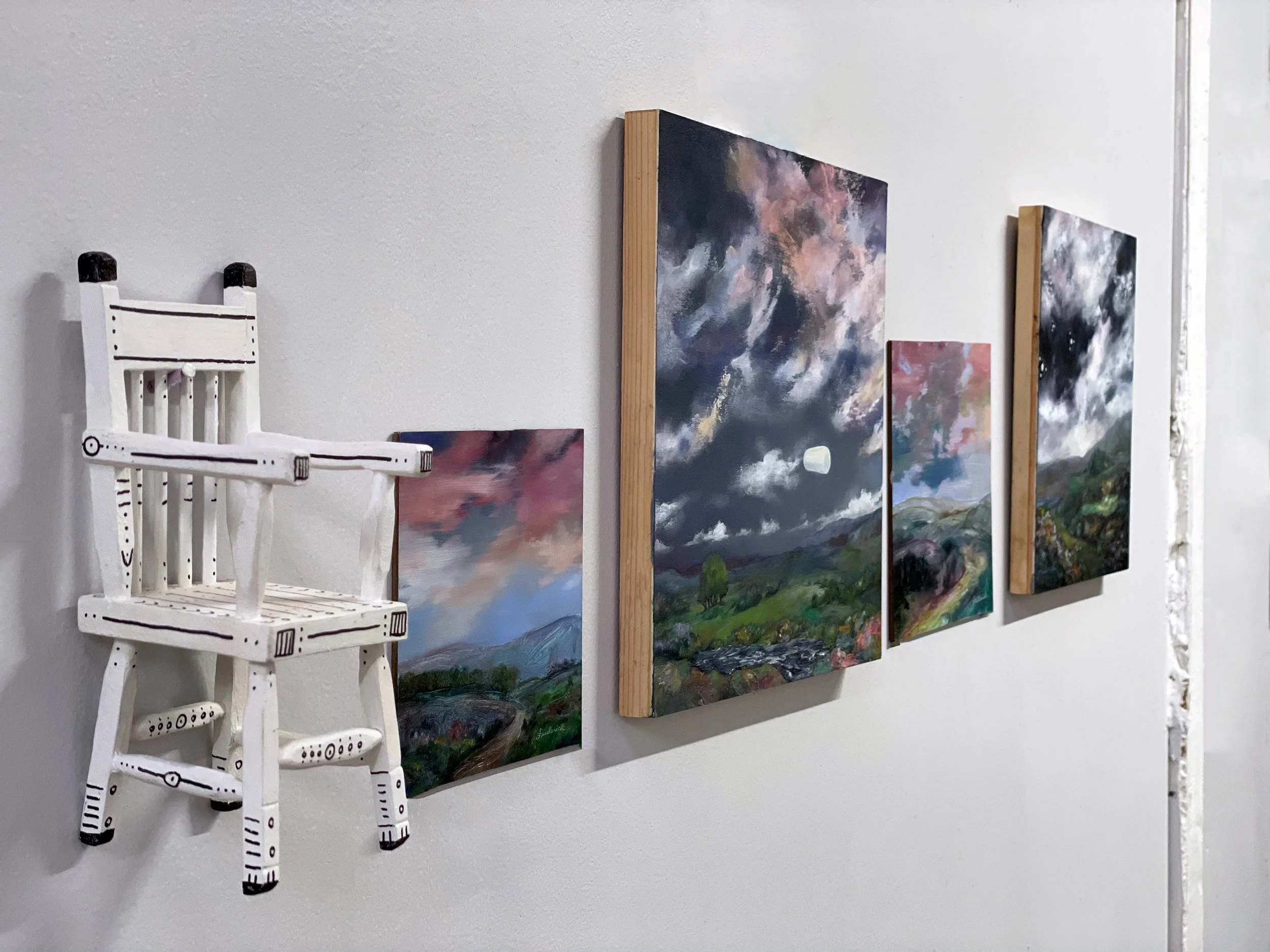 Contemporary fine art by Paula L. Frederick. Frederick's Sandpaper Factory studio wall hung with oil paintings and her Zebra Chair.