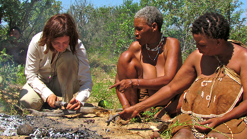 Here Tsumxai and Koba are teaching one of our participants about how they cook on the fire and how they open the maramba beans.