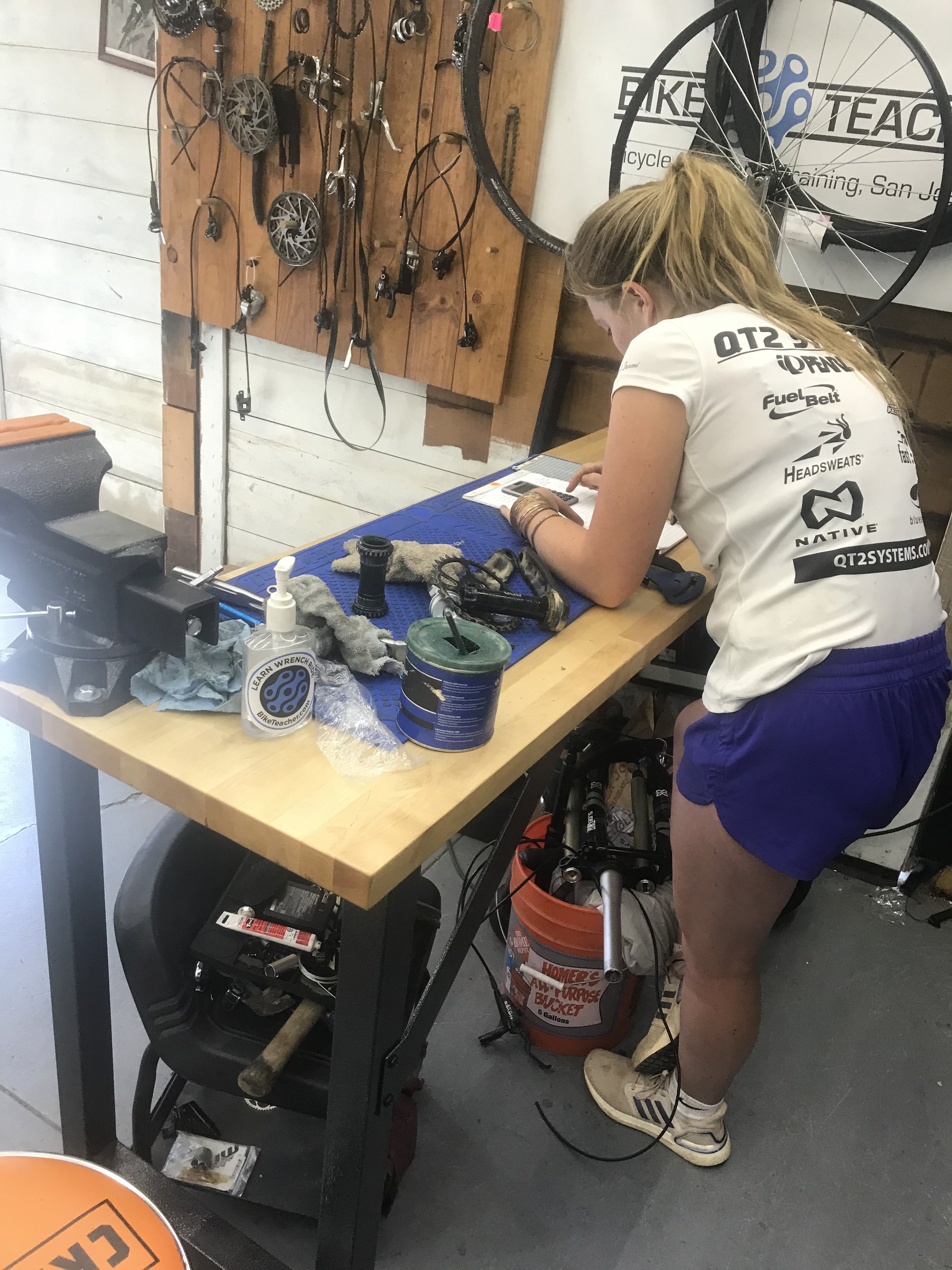 Female student receiving hands-on bicycle mechanic training at Bike Teacher in San Jose, California