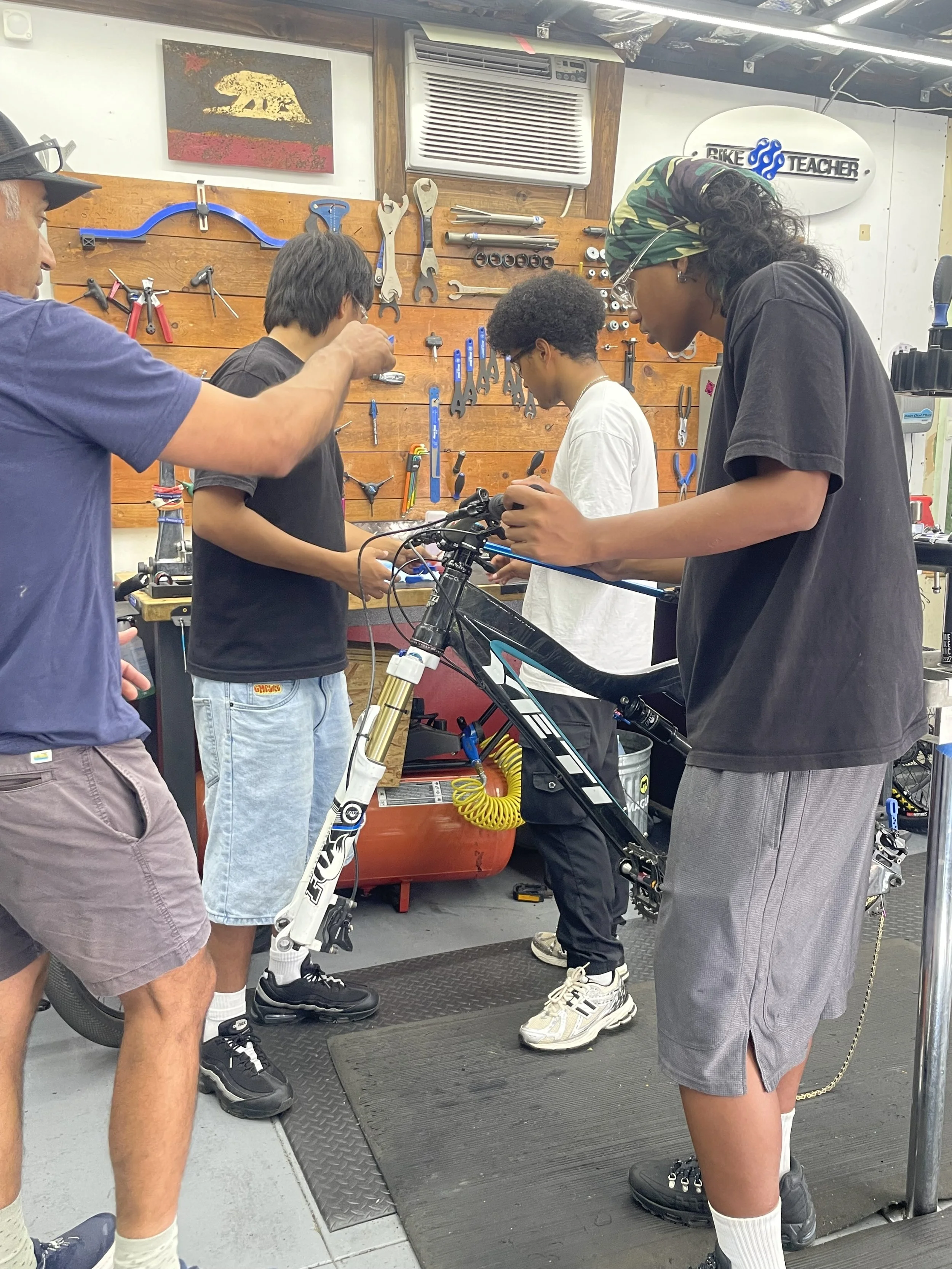 Students from Hawaii receiving hands-on bicycle mechanic training at Bike Teacher in San Jose, California