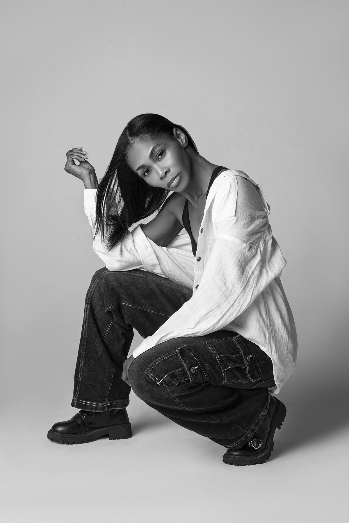 Kia posing confidently in a stylish outfit during an editorial photoshoot in a photography studio in Alpharetta, GA, highlighting her professional modeling skills.