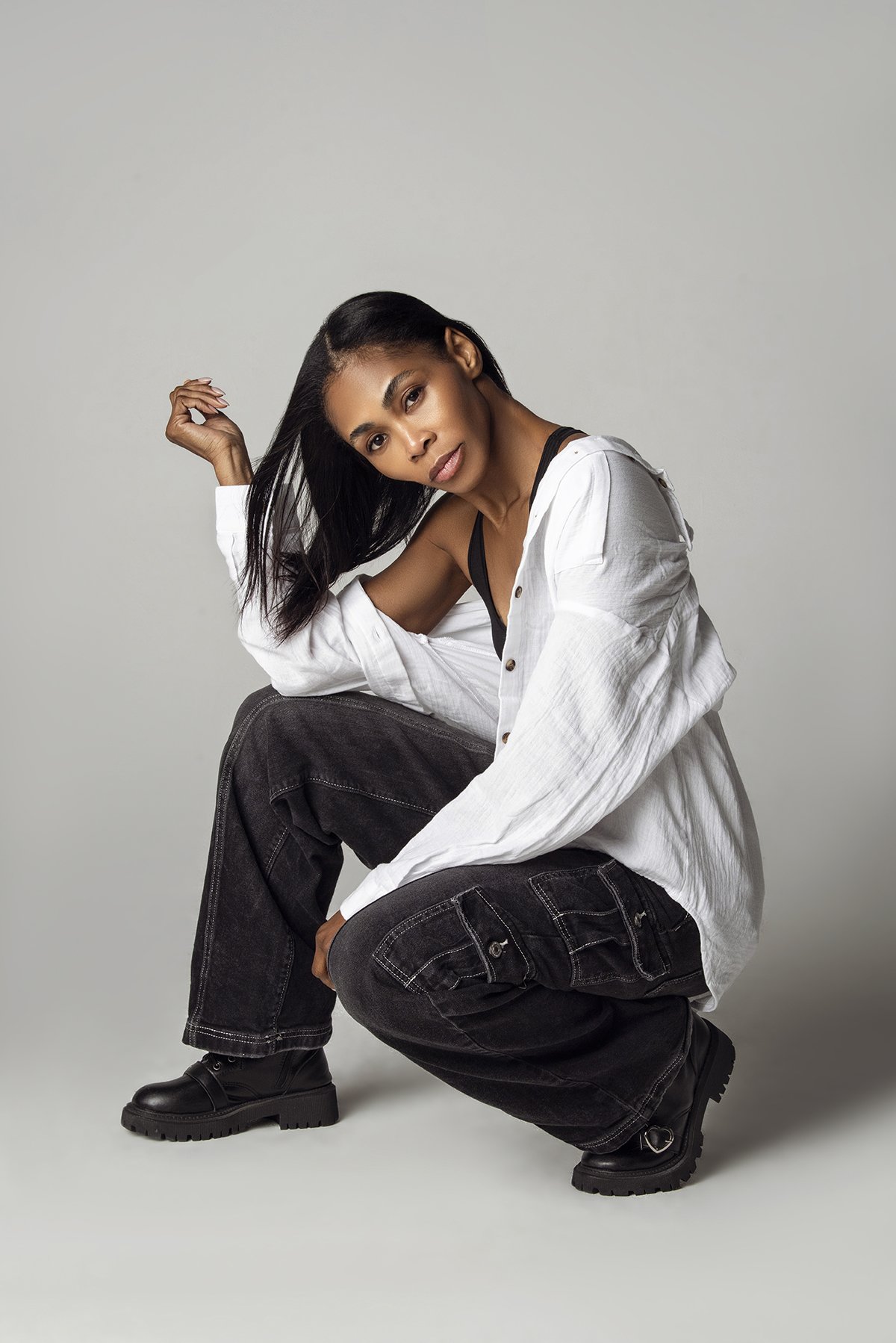 Kia posing confidently in a stylish outfit during an editorial photoshoot in a photography studio in Alpharetta, GA, highlighting her professional modeling skills.