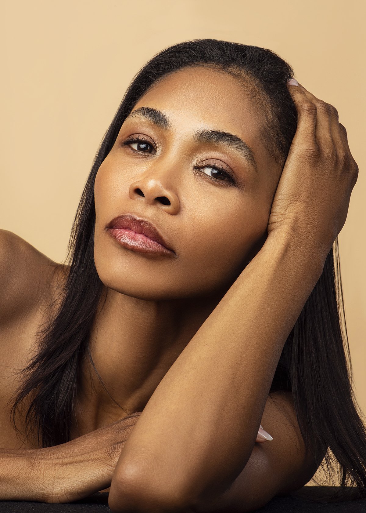 Close-up beauty portrait of Kia in the studio in Alpharetta, GA, with elegant makeup and a soft expression, showcasing her classic modeling style.