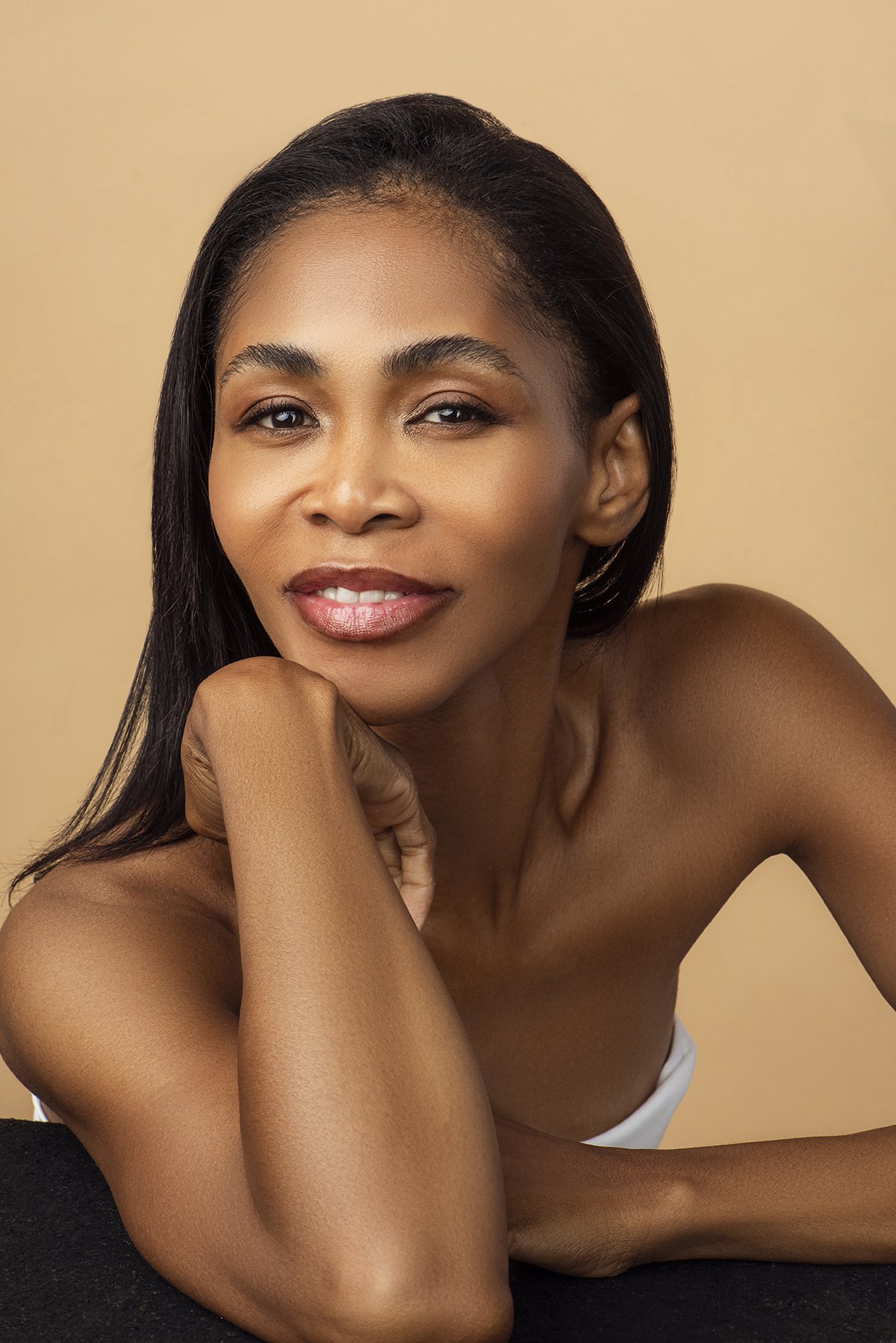 Close-up beauty portrait of Kia in the studio in Alpharetta, GA, with elegant makeup and a soft expression, showcasing her classic modeling style.