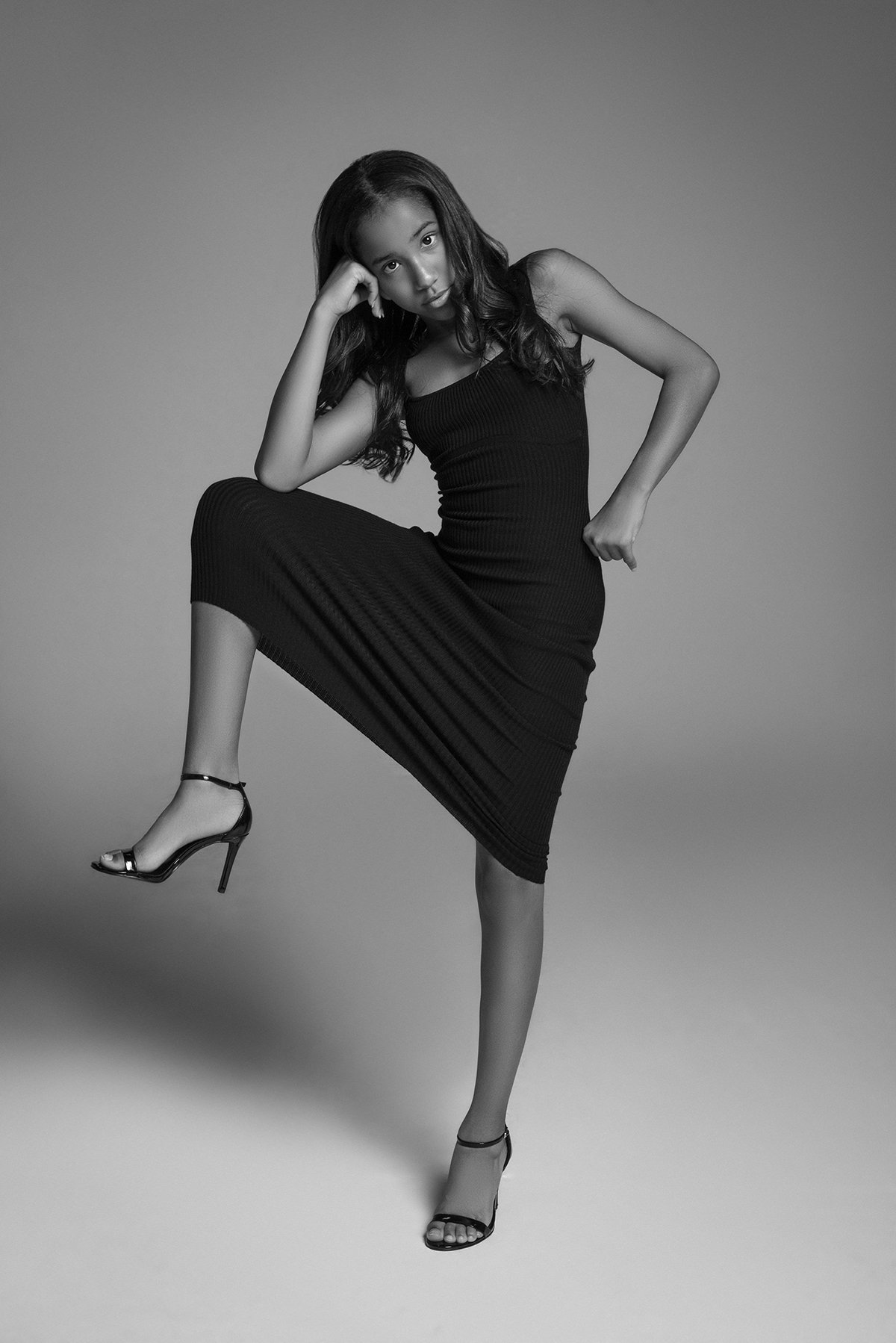 Editorial-style photo of Kia posing in an elegant dress in a photography studio in Alpharetta, GA, showcasing her updated modeling portfolio.
