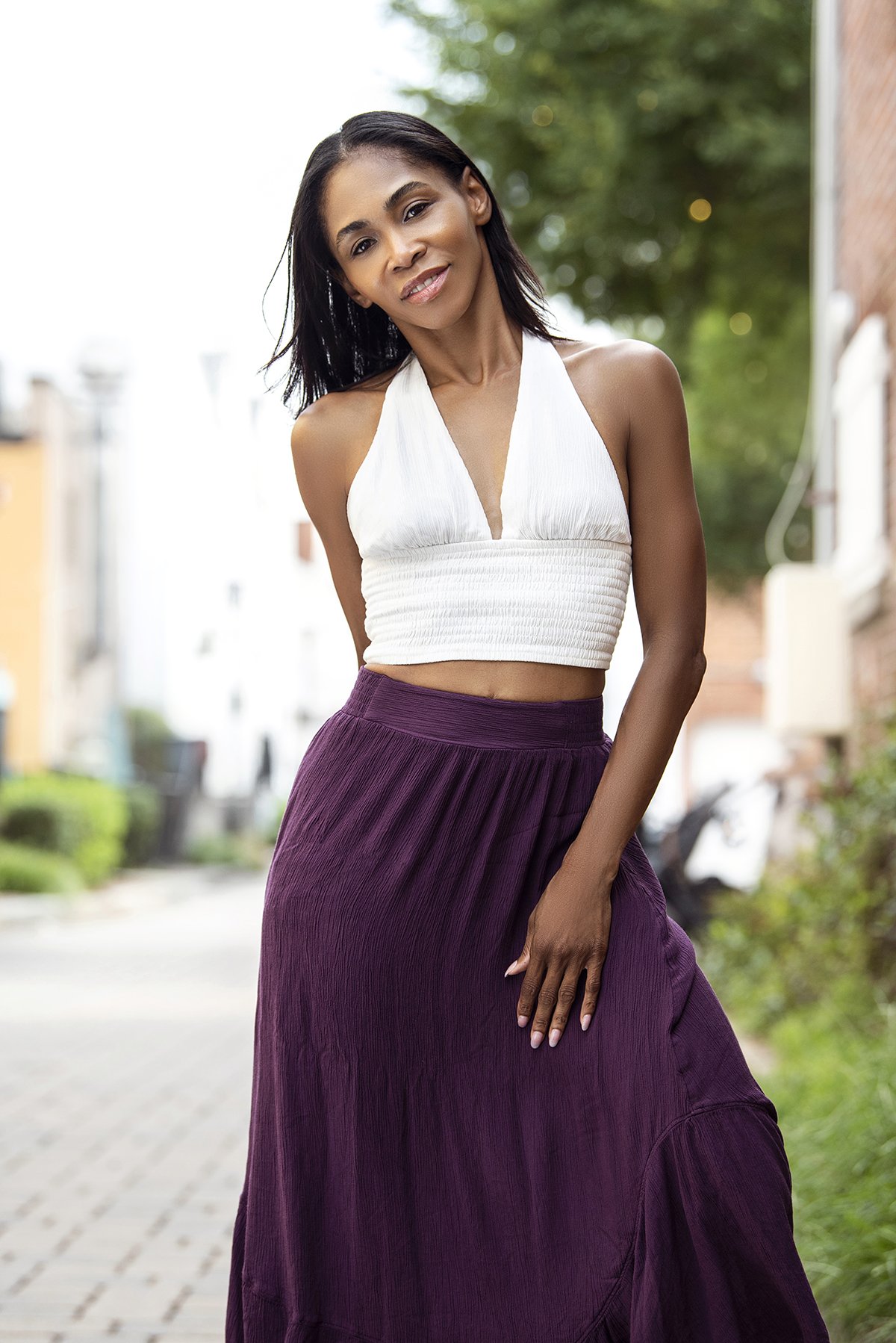 Kia standing in a relaxed pose outdoors in Downtown Marietta, GA, for a lifestyle photoshoot, surrounded by urban scenery with natural light.