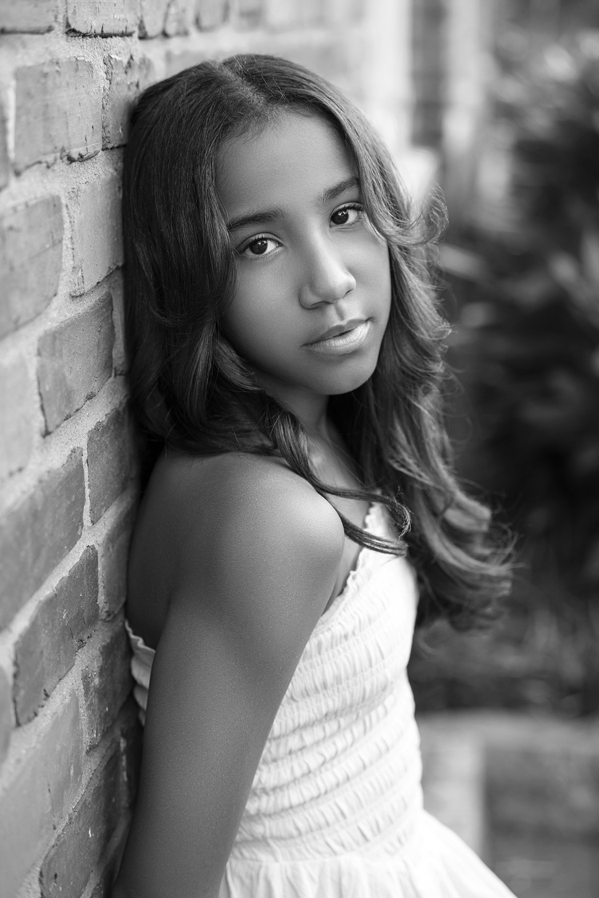 Kira posing outdoors in Downtown Marietta, GA, for a lifestyle modeling portfolio shot, with a cityscape background and natural lighting.