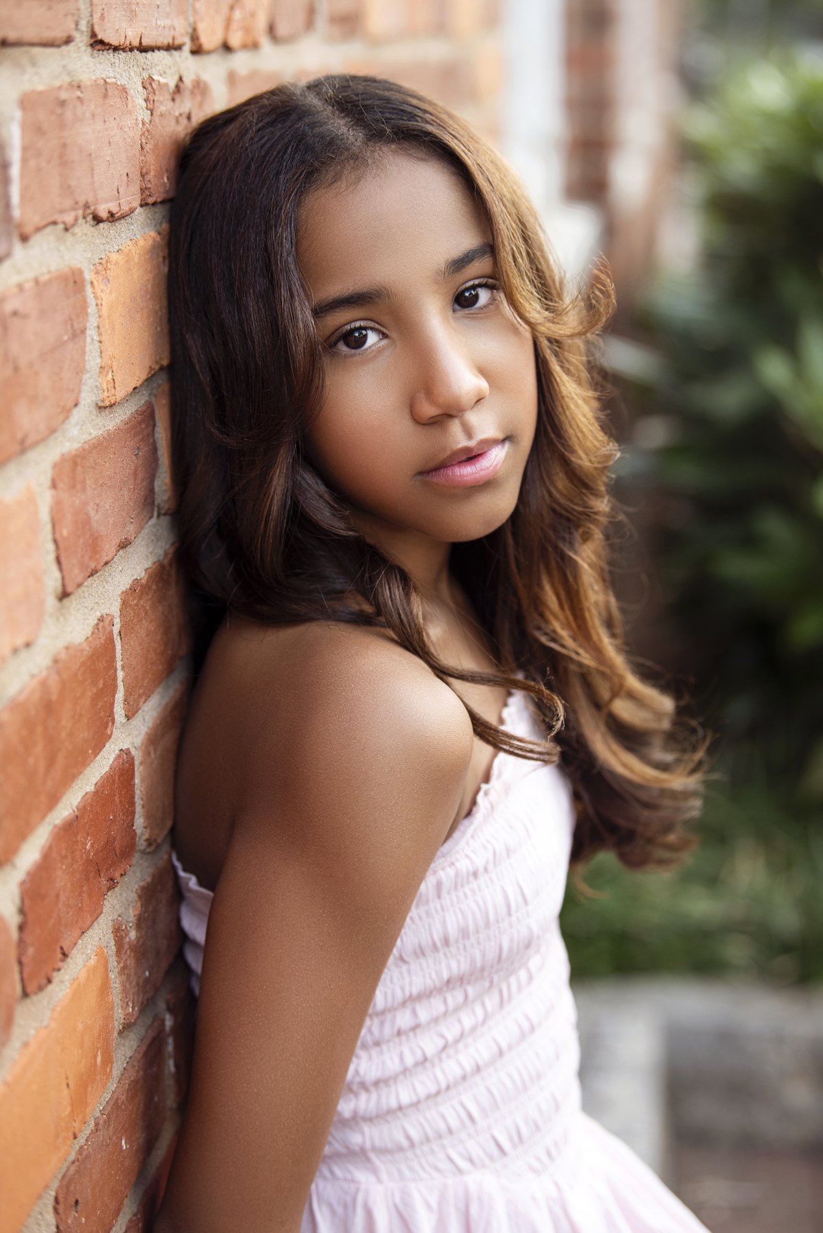Kira posing outdoors in Downtown Marietta, GA, for a lifestyle modeling portfolio shot, with a cityscape background and natural lighting.