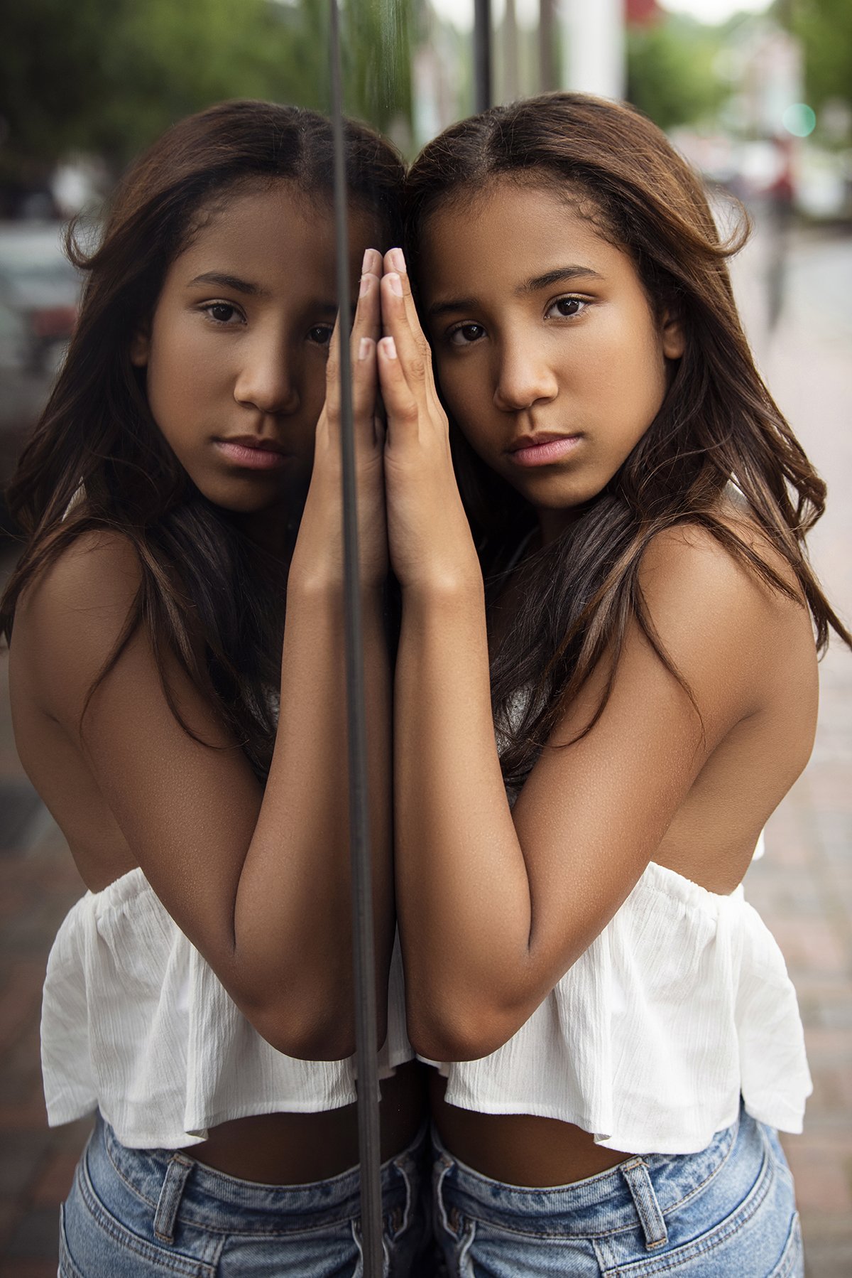 Kira posing outdoors in Downtown Marietta, GA, for a lifestyle modeling portfolio shot, with a cityscape background and natural lighting.