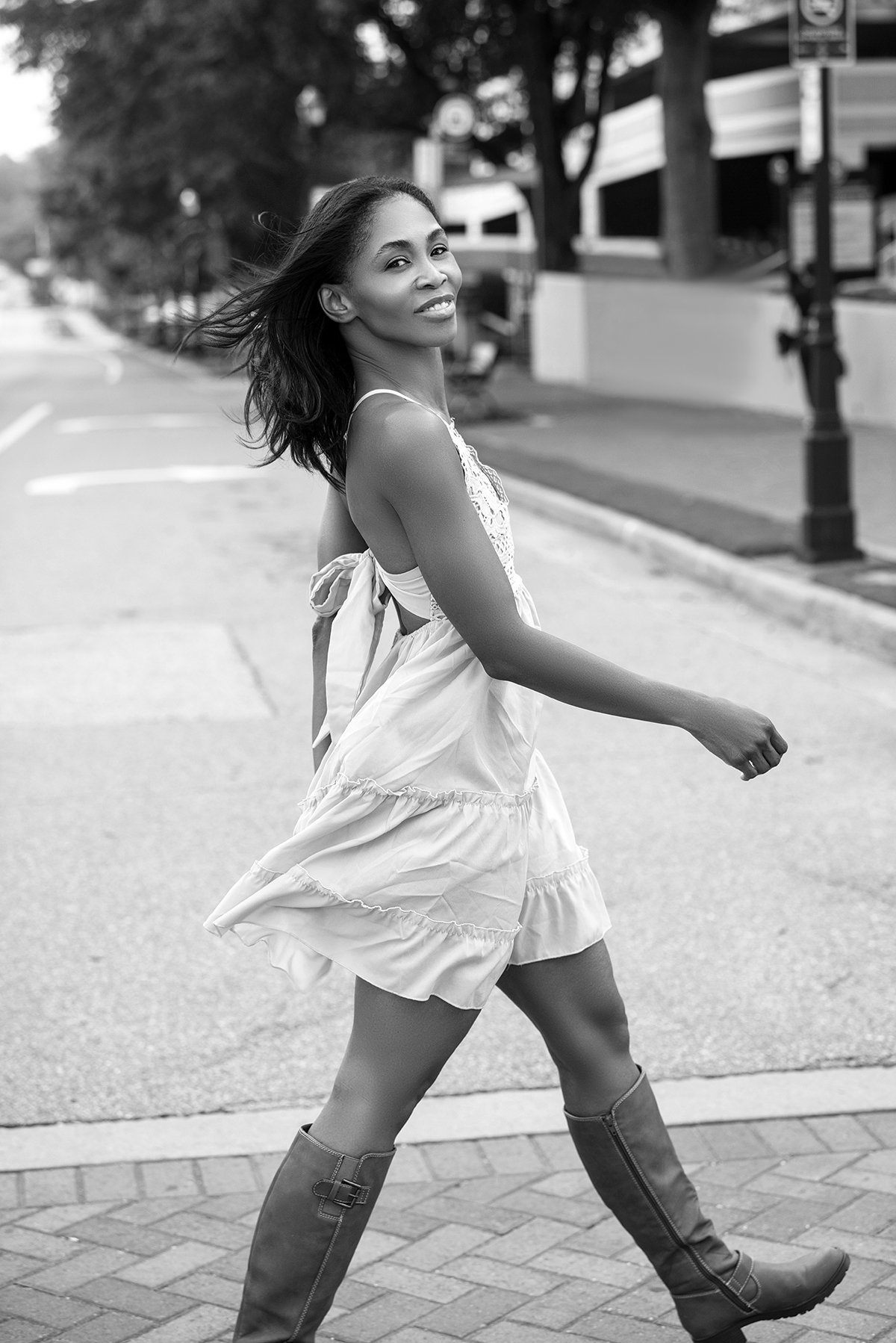 Kia standing in a relaxed pose outdoors in Downtown Marietta, GA, for a lifestyle photoshoot, surrounded by urban scenery with natural light.