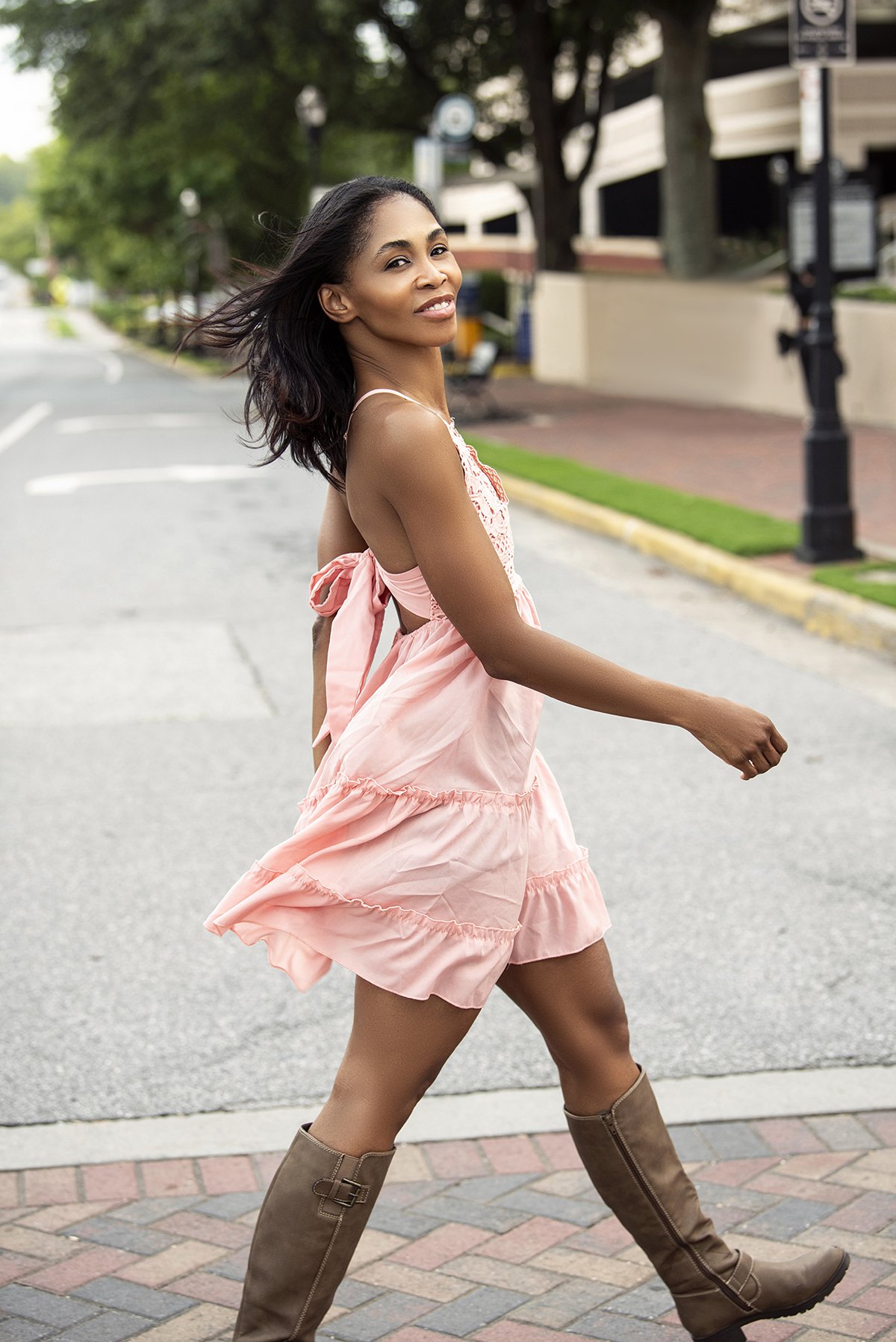Kia standing in a relaxed pose outdoors in Downtown Marietta, GA, for a lifestyle photoshoot, surrounded by urban scenery with natural light.