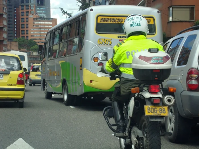 We follow a police officer weaving through Bogota traffic on his motorcycle.