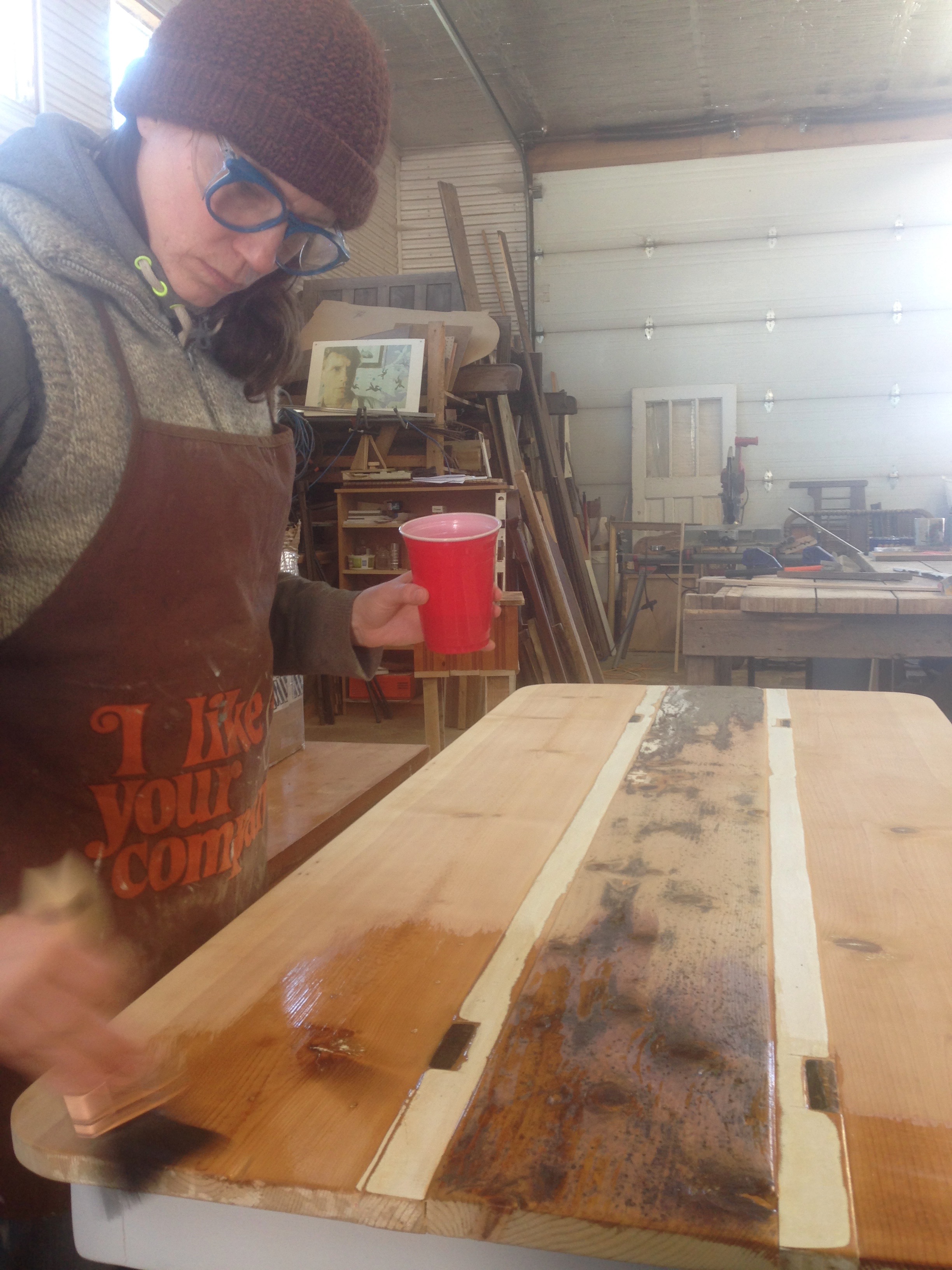 Heather's all bundled up to apply Tung Oil.