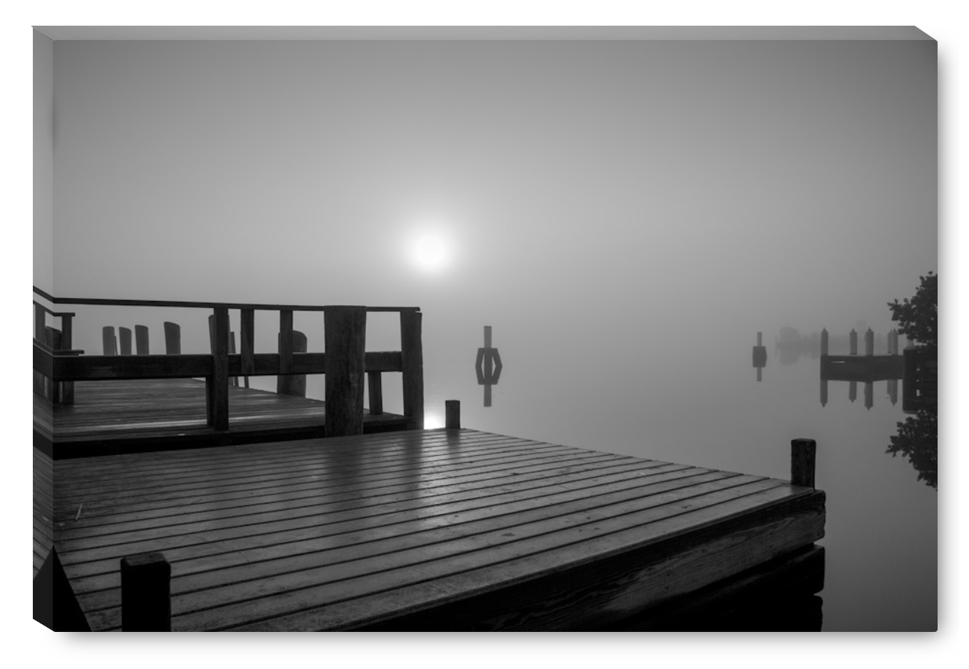 Shoreline docks apear along Long Island Sound as the rising sun burns off the mist.