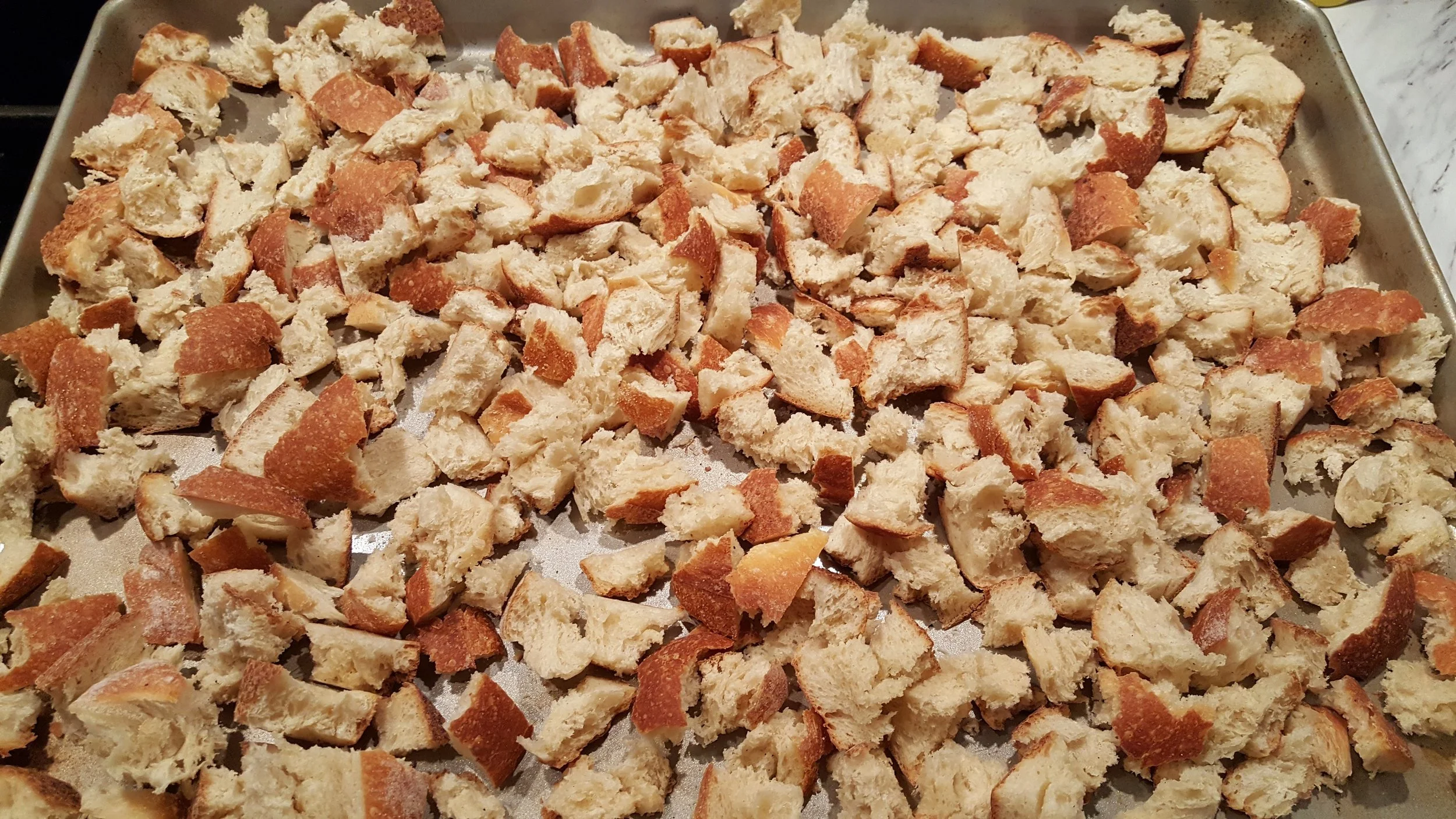 Step 1: Tear up bread into small pieces onto cookie sheets. Leave in oven at 250 degrees until hard and golden brown, about 30 minutes; darker if you prefer.