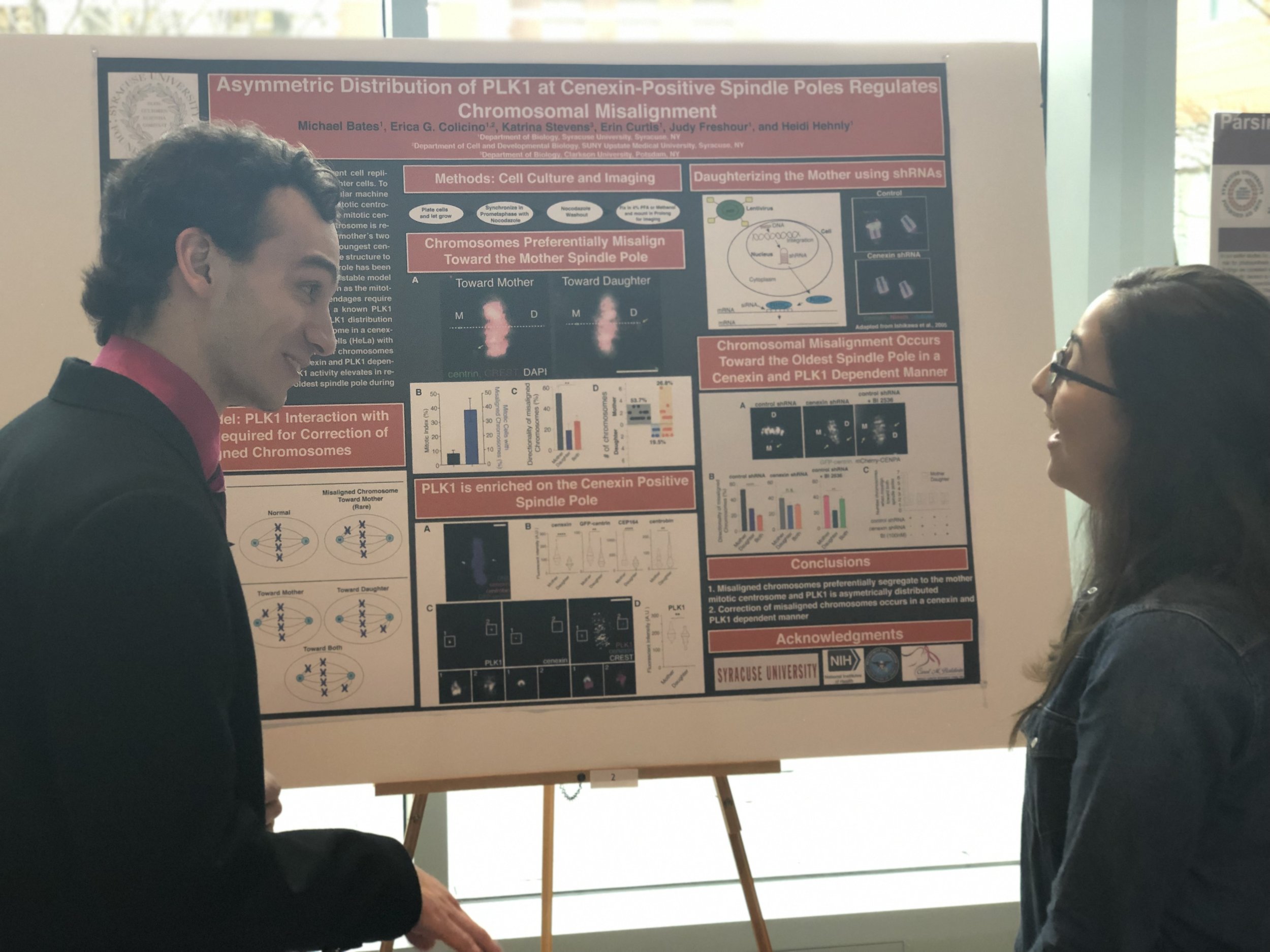 Michael presenting his poster to a Hehnly Lab Alum, Alice. This work was done in collaboration with Erica Colicino (Hehnly Lab, currently at University of Michigan).