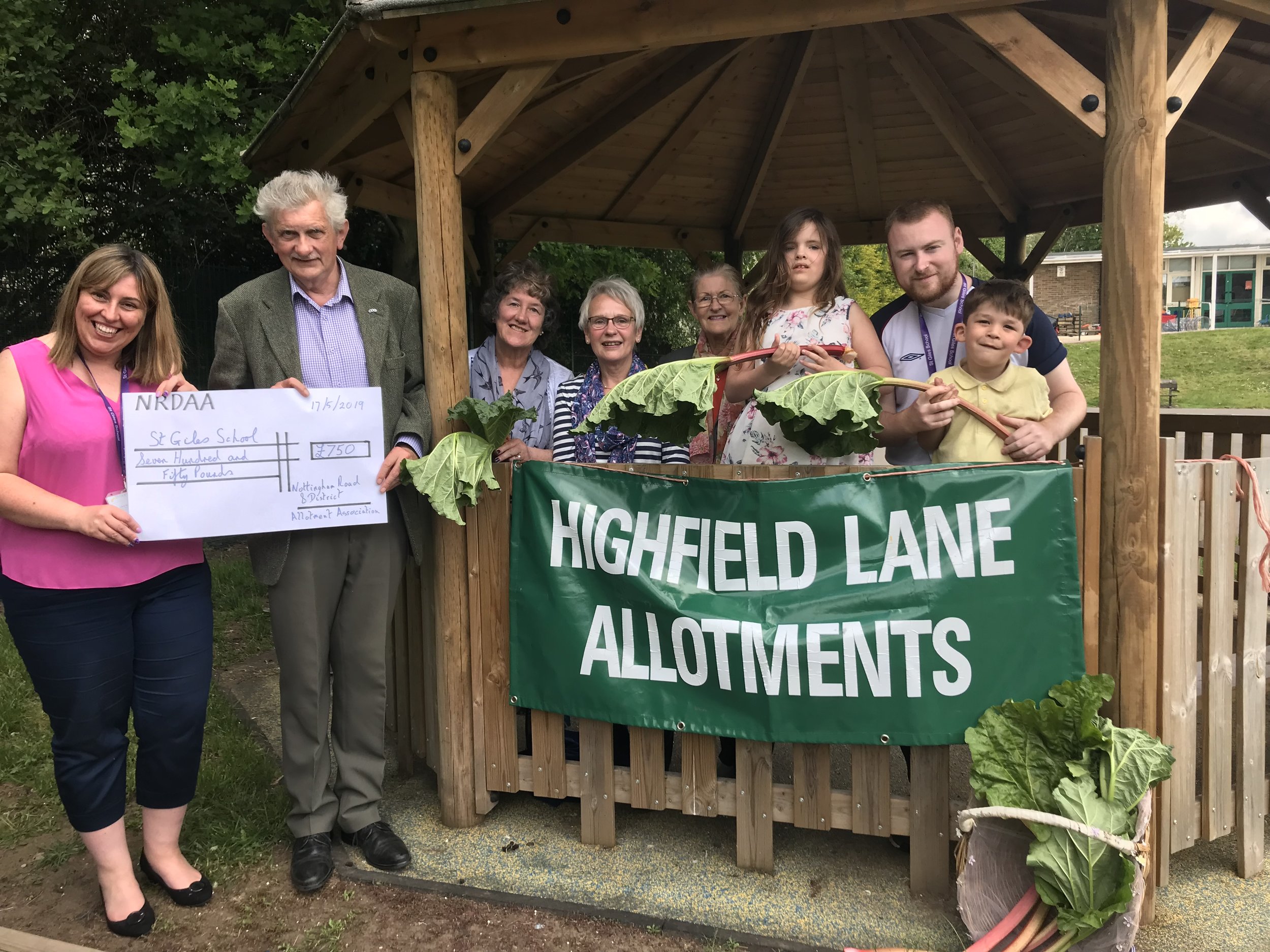 Pictures shows (from left) St Giles School deputy headteacher Laura Taylor receiving a cheque for £750 from Highfield Lane allotment treasurer, Colin Smith. Back row (from left): Ellen Taylor, Sue James, Mary Smith, Leah Oldsrth, Rob Moore (teaching…