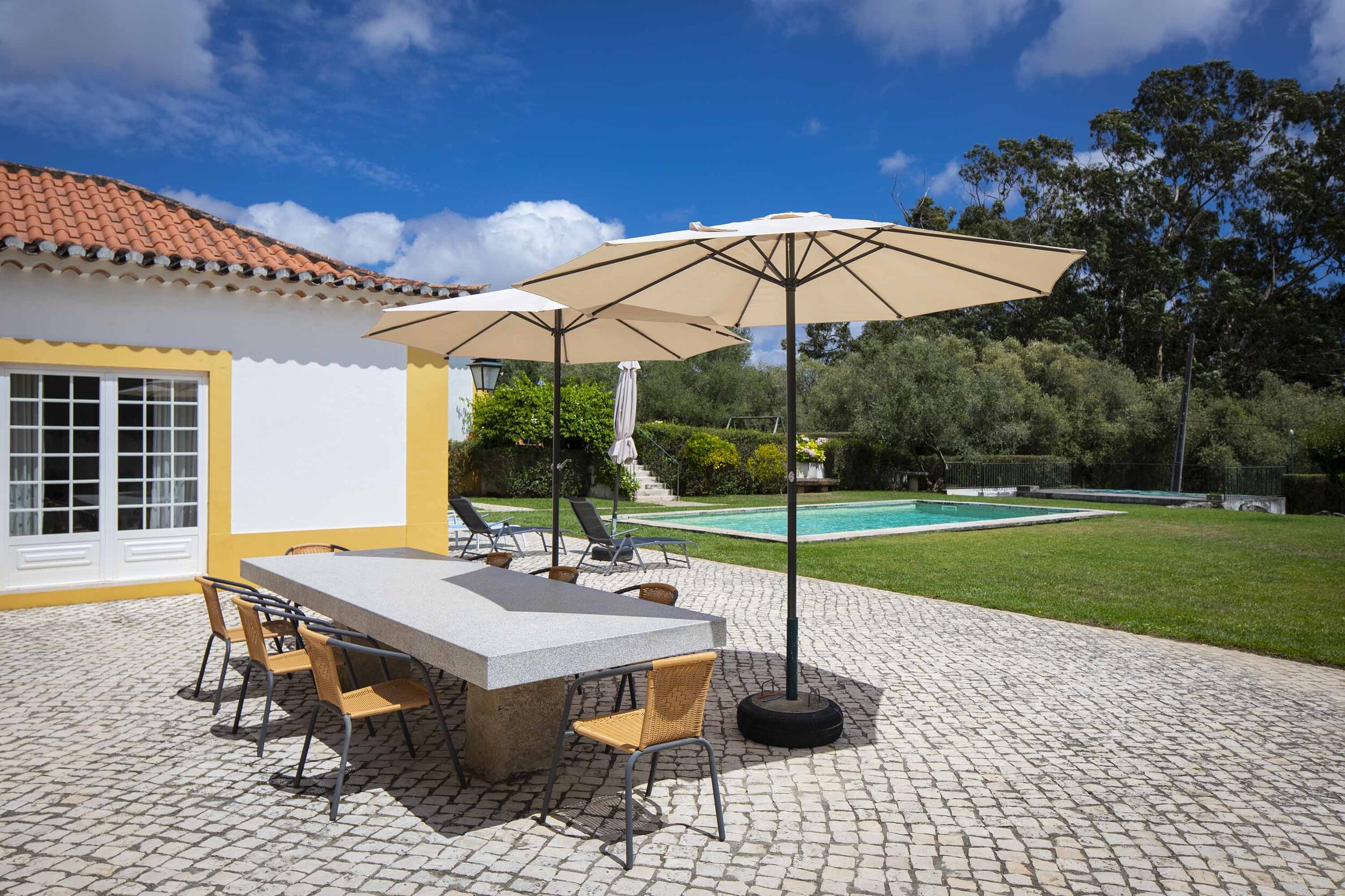 A typical country house is set in lush gardens boasting citrus trees, aromatic herbs, vibrant hydrangeas and blushing bougainvillea. The outdoor swimming pool includes a spacious sun terrace and dining area, as well as a open air barbecue