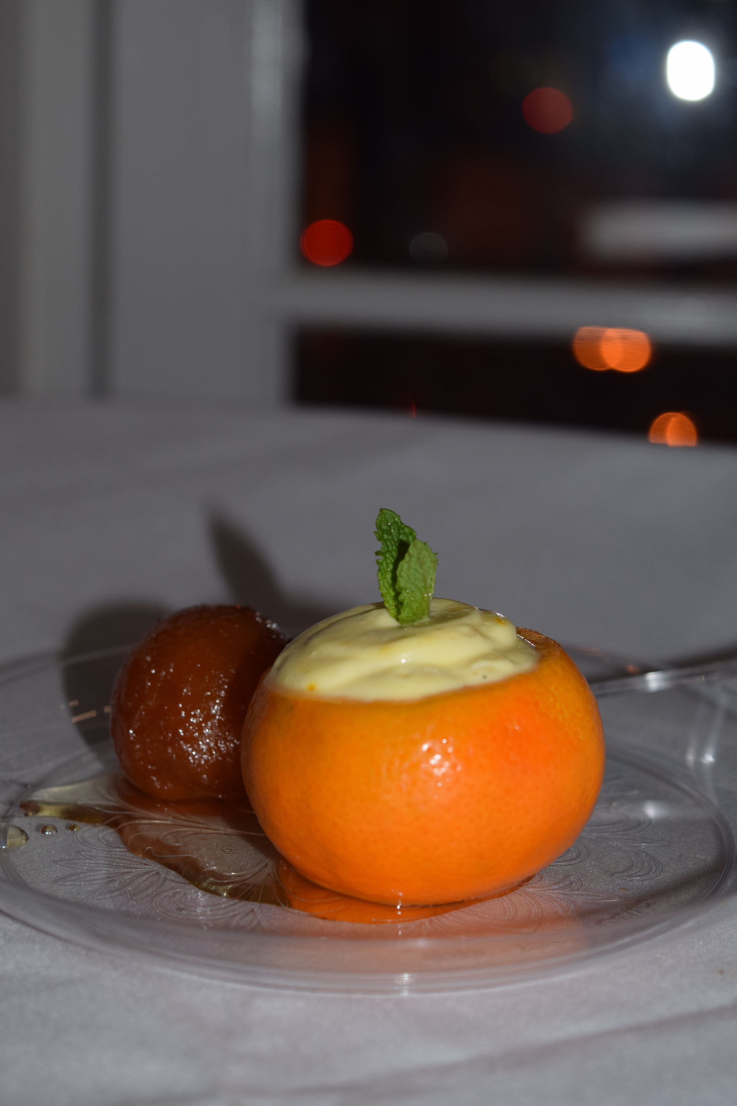 GULAB JAMUN (milk solid donut hole, honey and vanilla ice cream) and ORANGE SHREEKANDH (yogurt, pistachio, saffron and orange shell)