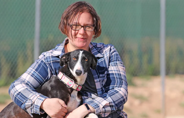 Tix enjoying a cuddle with volunteer Natalie.
