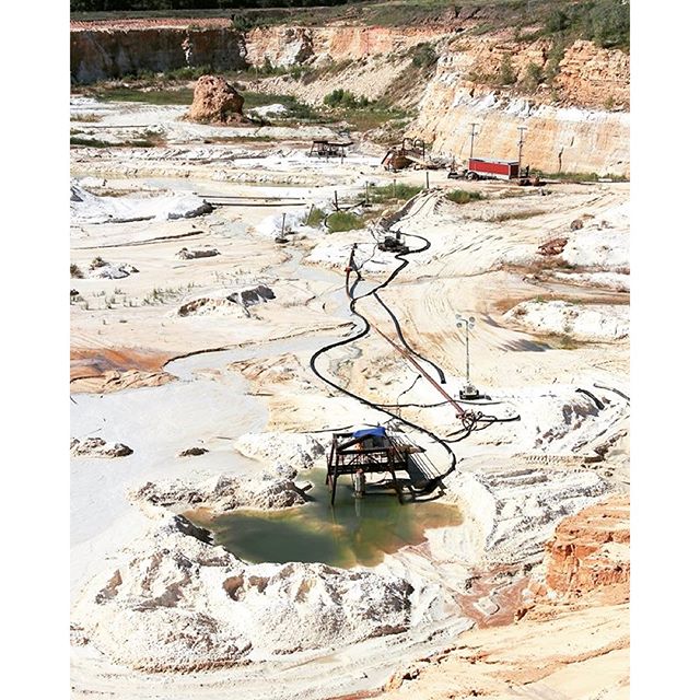 Open-pit sand quarry in the Ordovician-age Oil Creek Formation, Oklahoma.  The sandstone is relatively unconsolidated and is mined with water sprayed from a hose! This quarry produces some of the most uniformly sized, pure quartz sand in North Americ