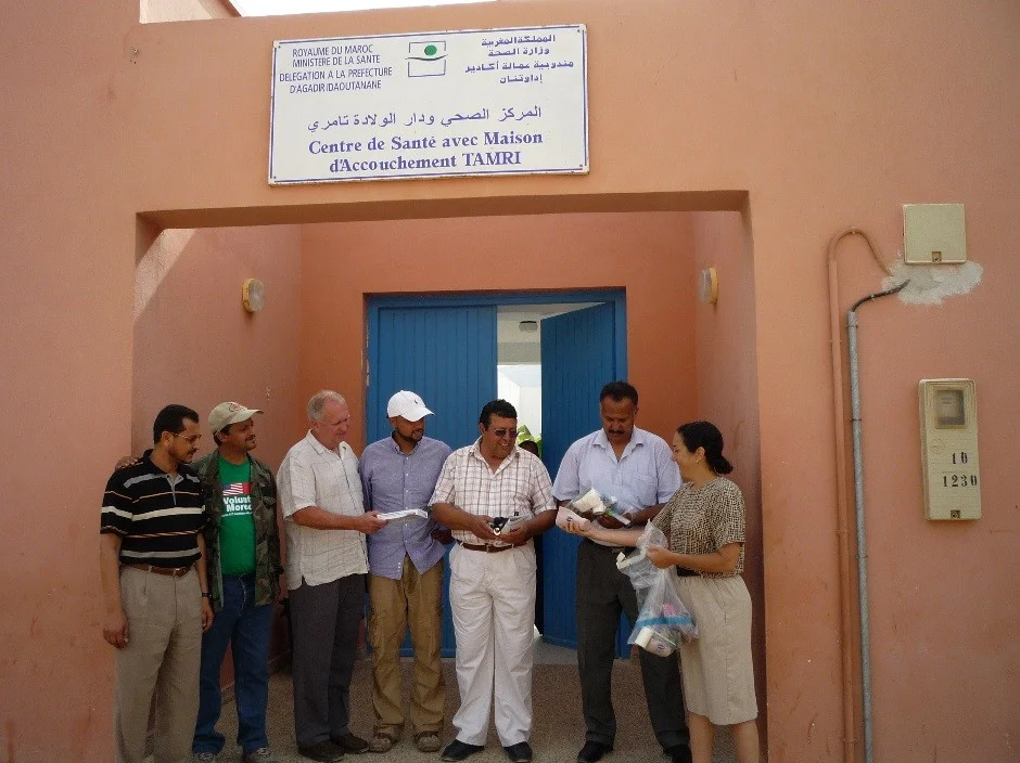 IMEC representatives giving gifts to Dr. Bouhsoune after assessment at Tamri dispensary