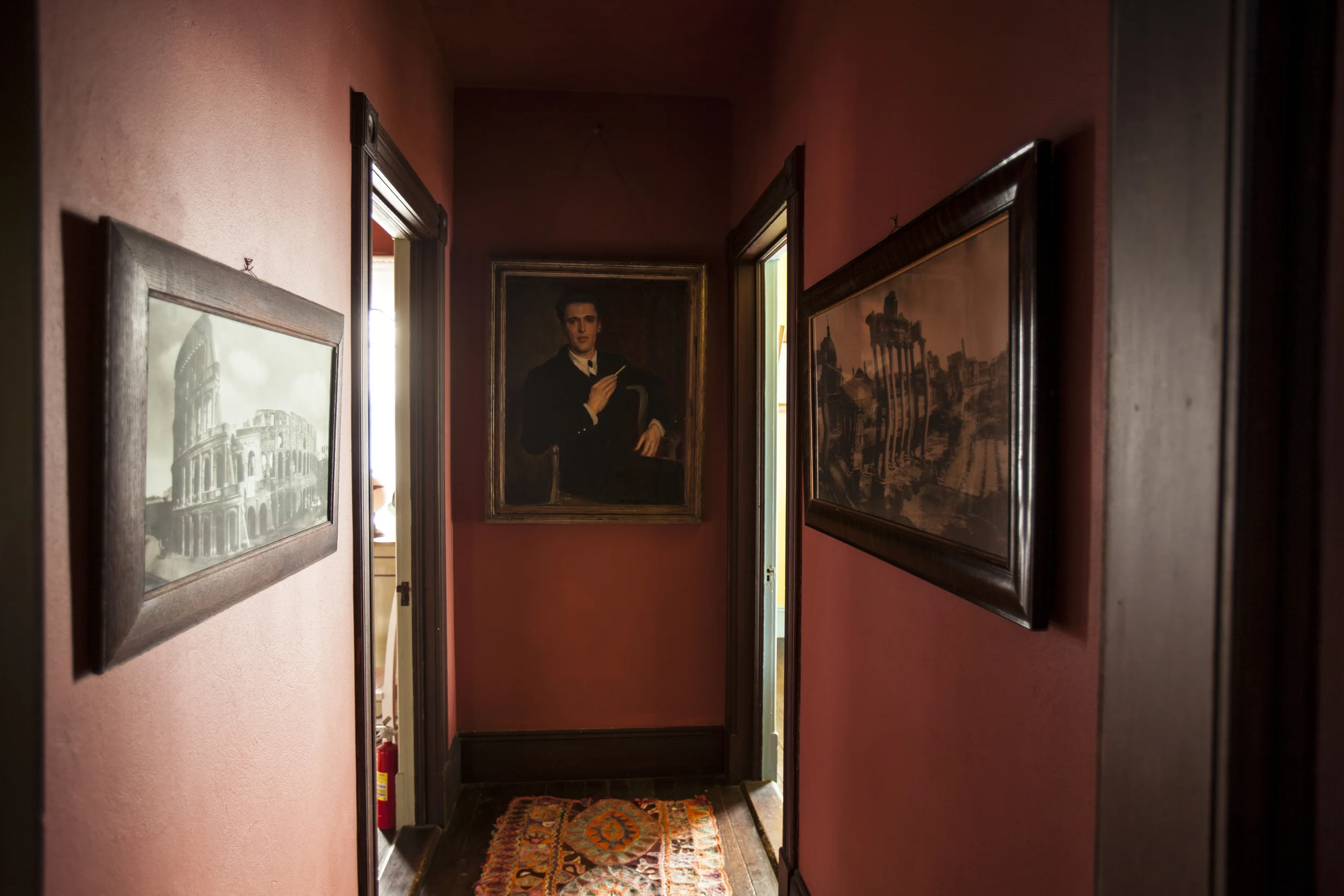 A portrait of John Walker hangs in a hallway.