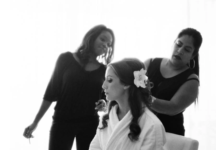 Alix Paige getting ready in her ivory crepe flower clip