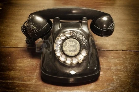 20494561-old-telephone-with-rotary-dial-on-old-wooden.jpg