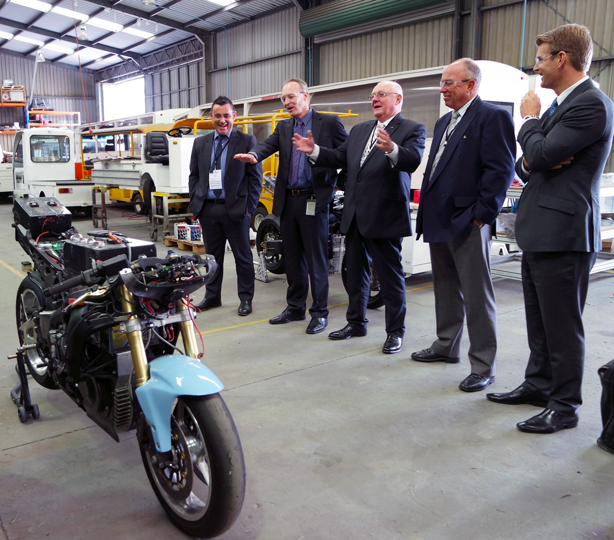 Pictured: Minister Barilaro (left) shares a laugh with Jeff Phillips (second left) whilst inspecting Varley's electric superbike.