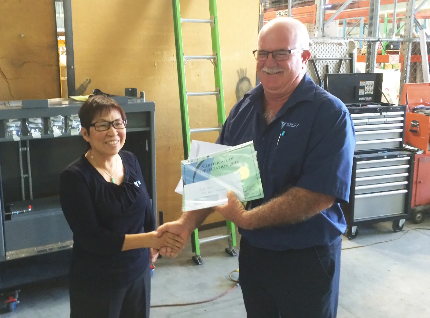 Eva receives her long service award from Varley's Queensland Operations Manager, Brendan Freshwater.