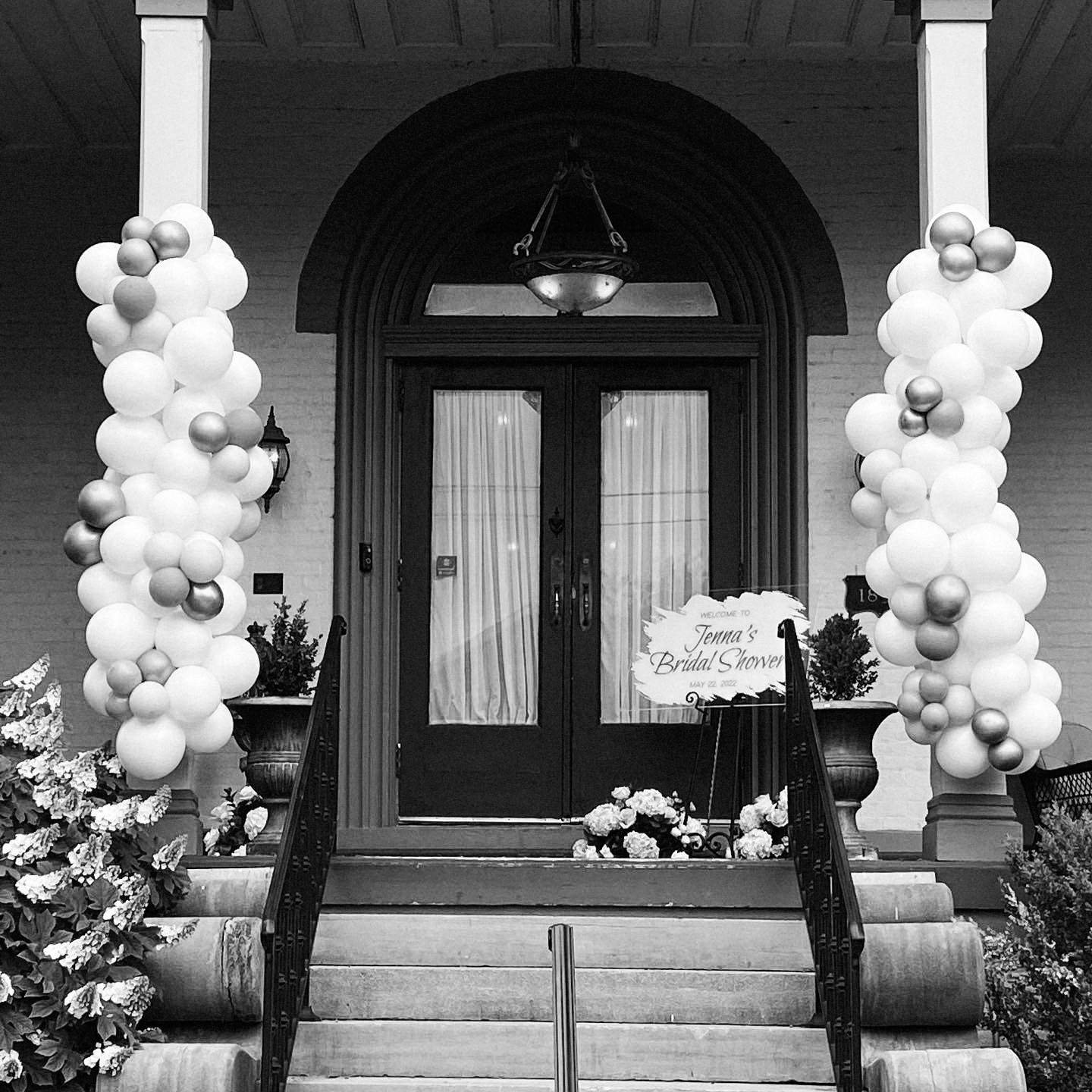  Balloon installations frame the entrance of a historic home for a fun and playful wedding shower 