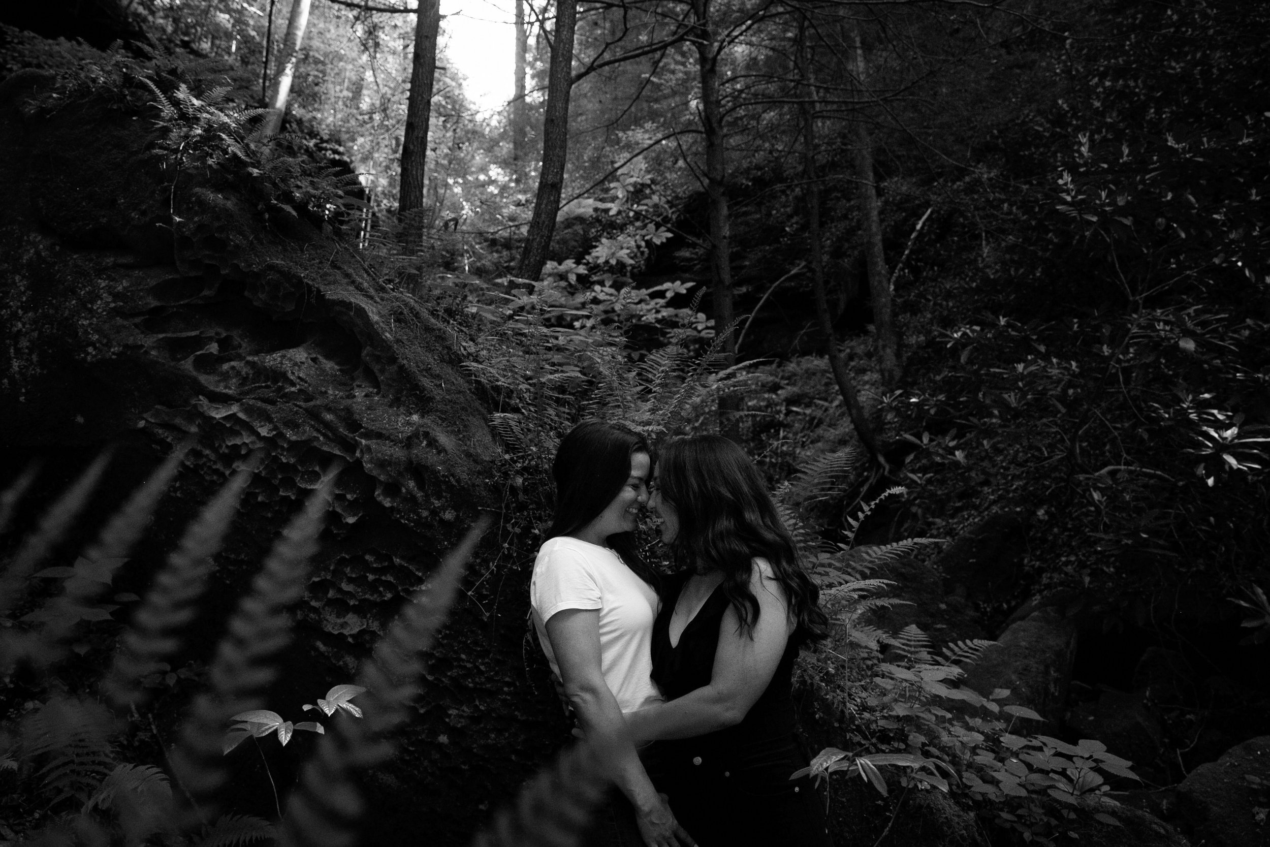  An LGBTQ couple hold each other during an engagement session at Natural Bridge coordinated and photographed by Red River Gorge Weddings 