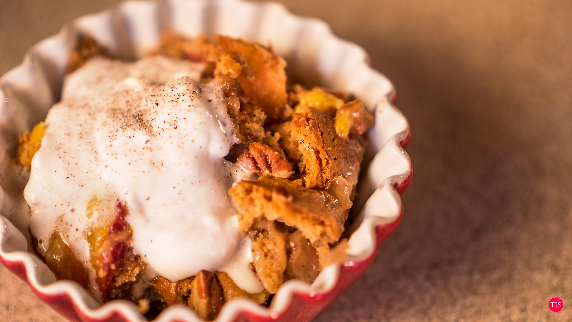 Jennifer Maring's Spiced Pecan Peach Cobbler recipe with coconut cream on top