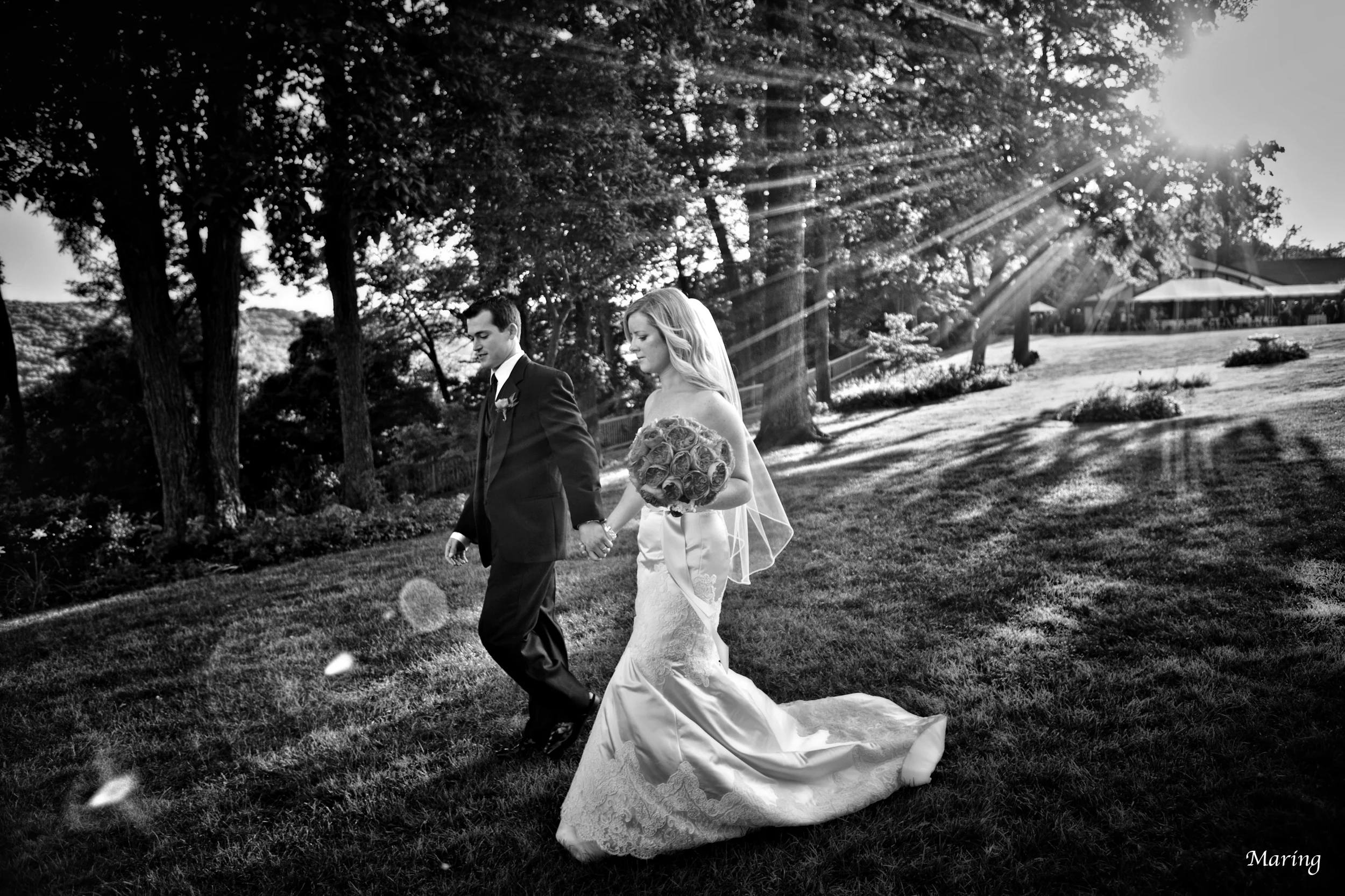 A couple takes a walk down to the river side at their wedding in Connecticut to spend some alone time together before headed to their cocktail hour.