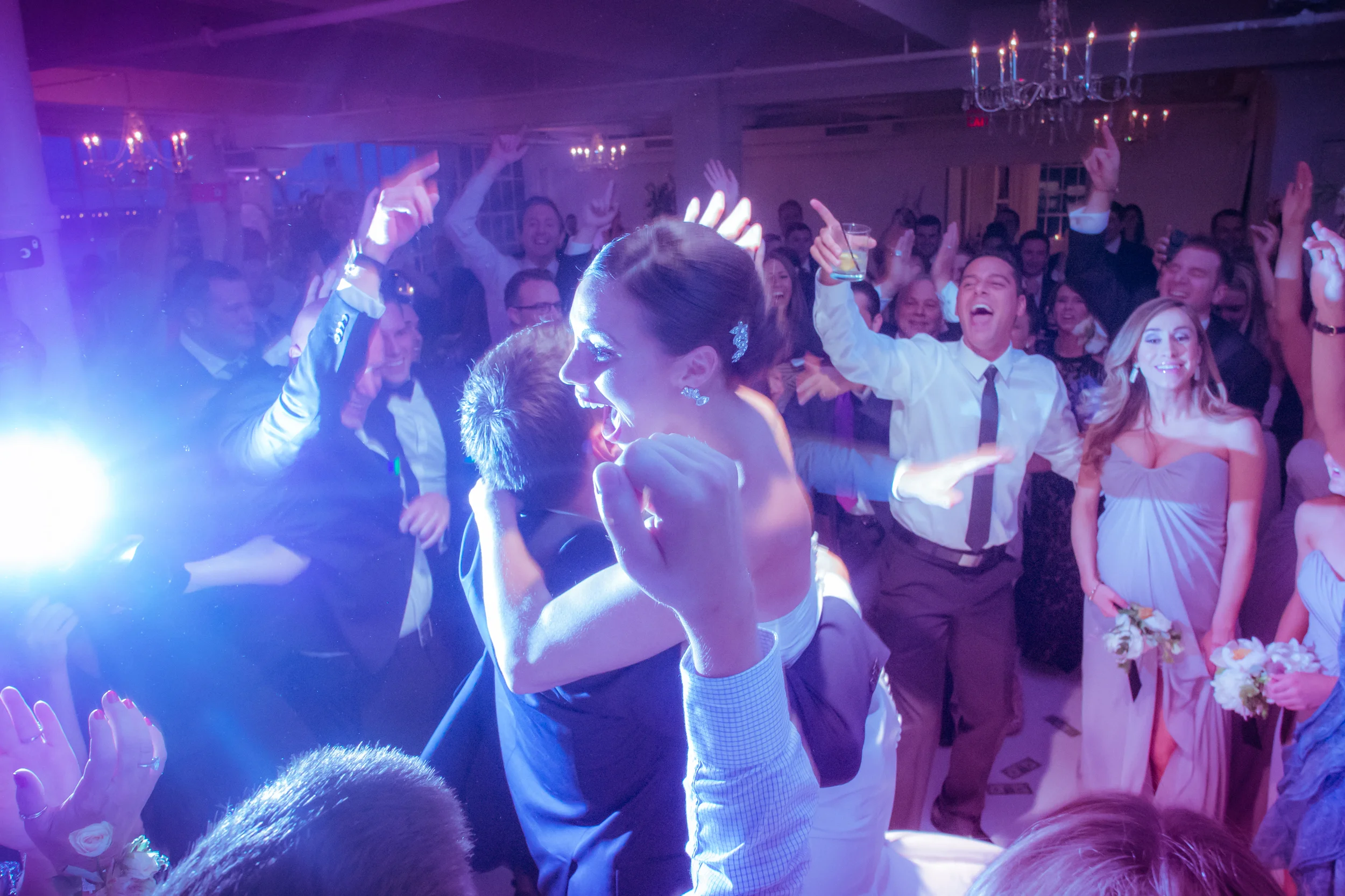 The groom lifts the bride and spins her around as guests cheer them on the dance floor. Make sure to spend time alongside your friends, but with a sense of togetherness as this couple did so well.