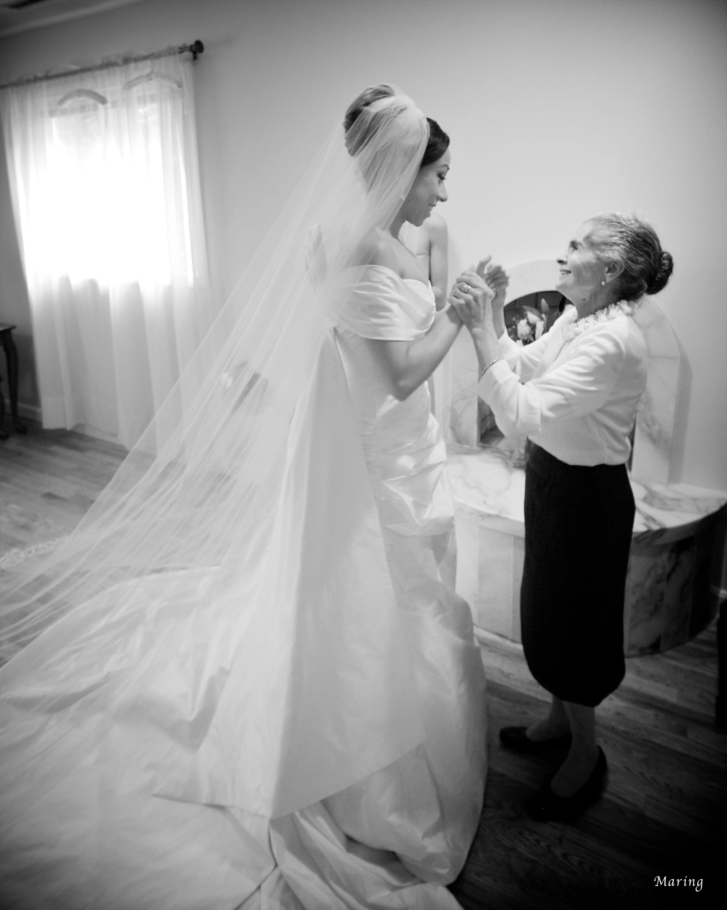 The grandmother of the bride shares a special moment with the bride after seeing her in the wedding dress for the first time. Moments like this only happen once in a lifetime, which is why it is so important to hire a photographer with a gifted eye for capturing meaningful moments.