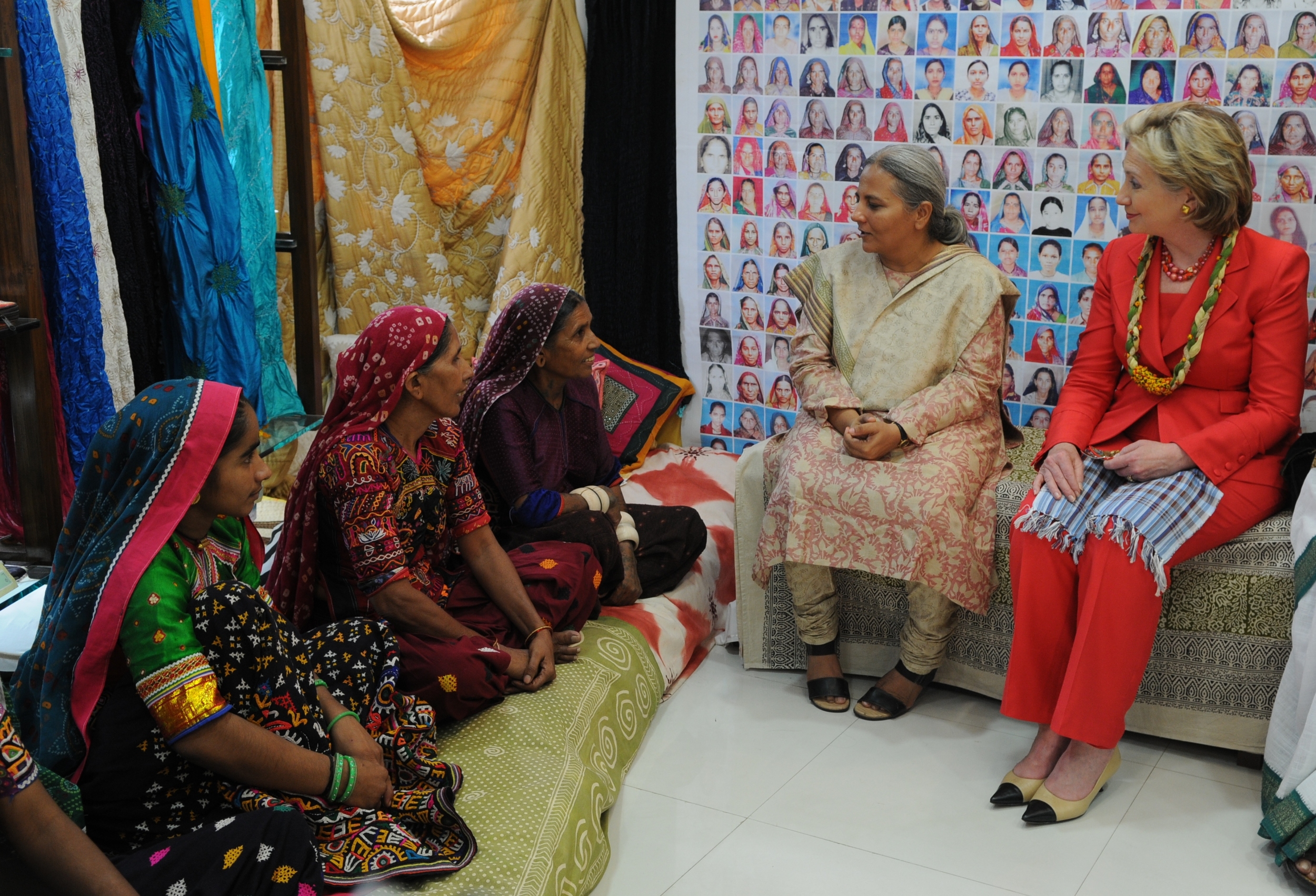 Secretary of State Clinton visiting Mumbai in 2009. Clinton listens to female artisans describe their work with SEWA which enabled them to be economically self-sufficient. 