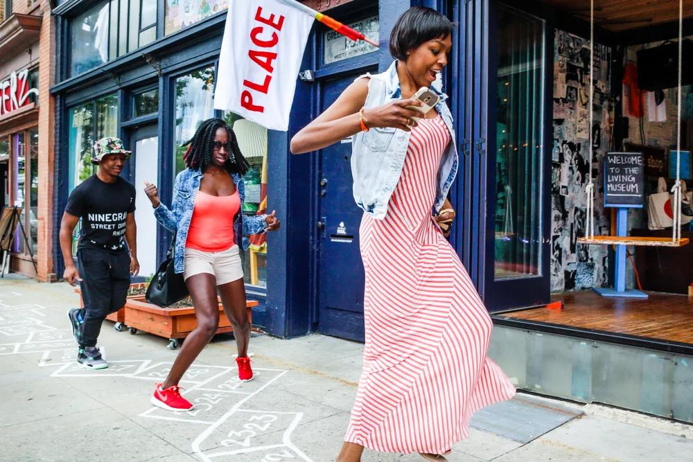 People hopping through downtown Greensboro, NC for Agustina Woodgate's Hopscotch, as part of Elsewhere's 2015 Curatorial Initiative, South Elm Projects. Photo courtesy of Elsewhere.