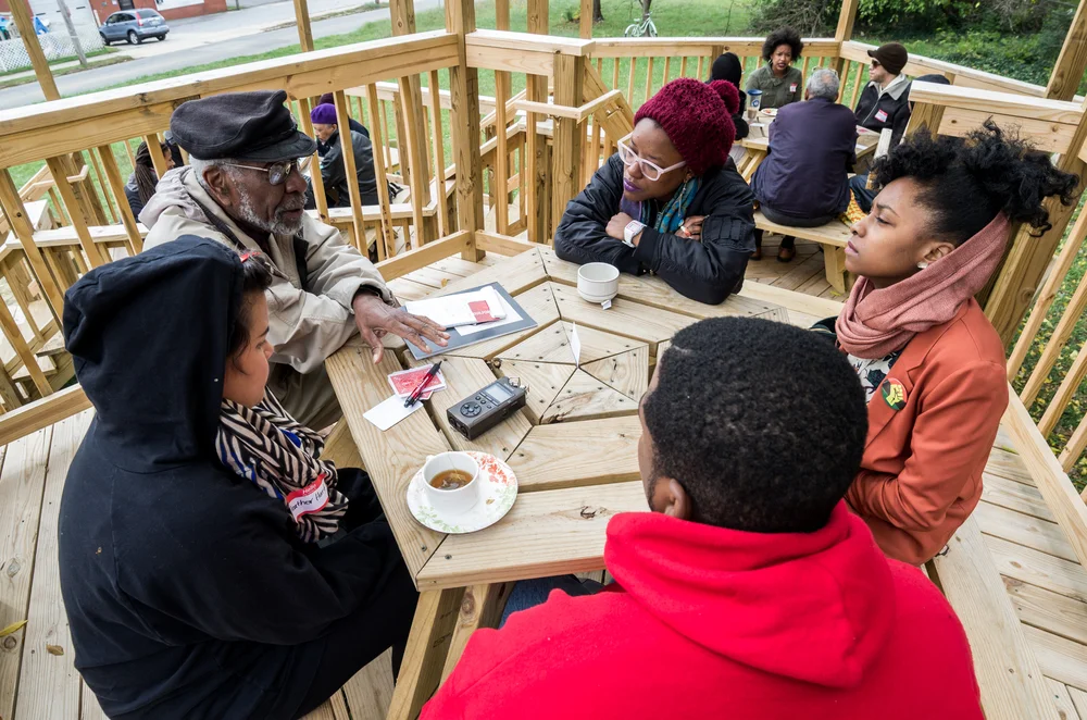 Discussion among Greensboro artists for Heather Hart's The Black Lunch Tables, as part of Elsewhere's 2015 Curatorial Initiative, South Elm Projects. Photo courtesy of Elsewhere.
