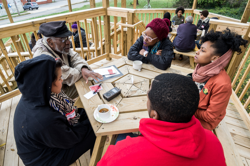 Discussion among Greensboro artists for Heather Hart's The Black Lunch Tables , as part of Elsewhere's 2015 Curatorial Initiative, South Elm Projects. Photo courtesy of Elsewhere.