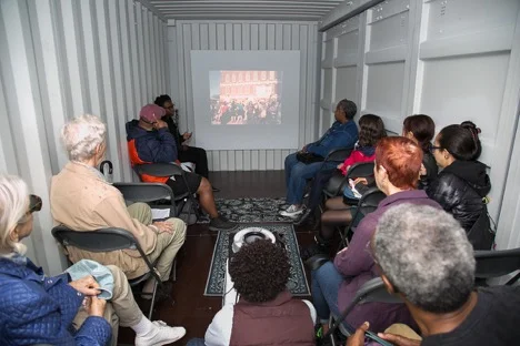 Sabrina Dorsainvil presents a slide talk in the Slideshow shipping container at HUBweek. Photo by Jean Hangarter