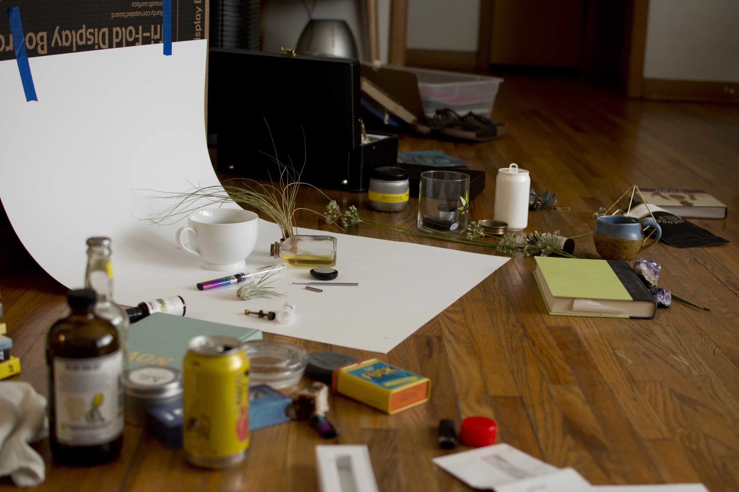 For my setup, I just use large sheets of paper, my coffee table, or the floor. I like using the paper for a smooth background, and it's really easy to move around the room as the light changes throughout the day. I'm lucky enough to have large windows that let in lots of light, but keep me out of the direct sunlight in the harsh parts of the day. 