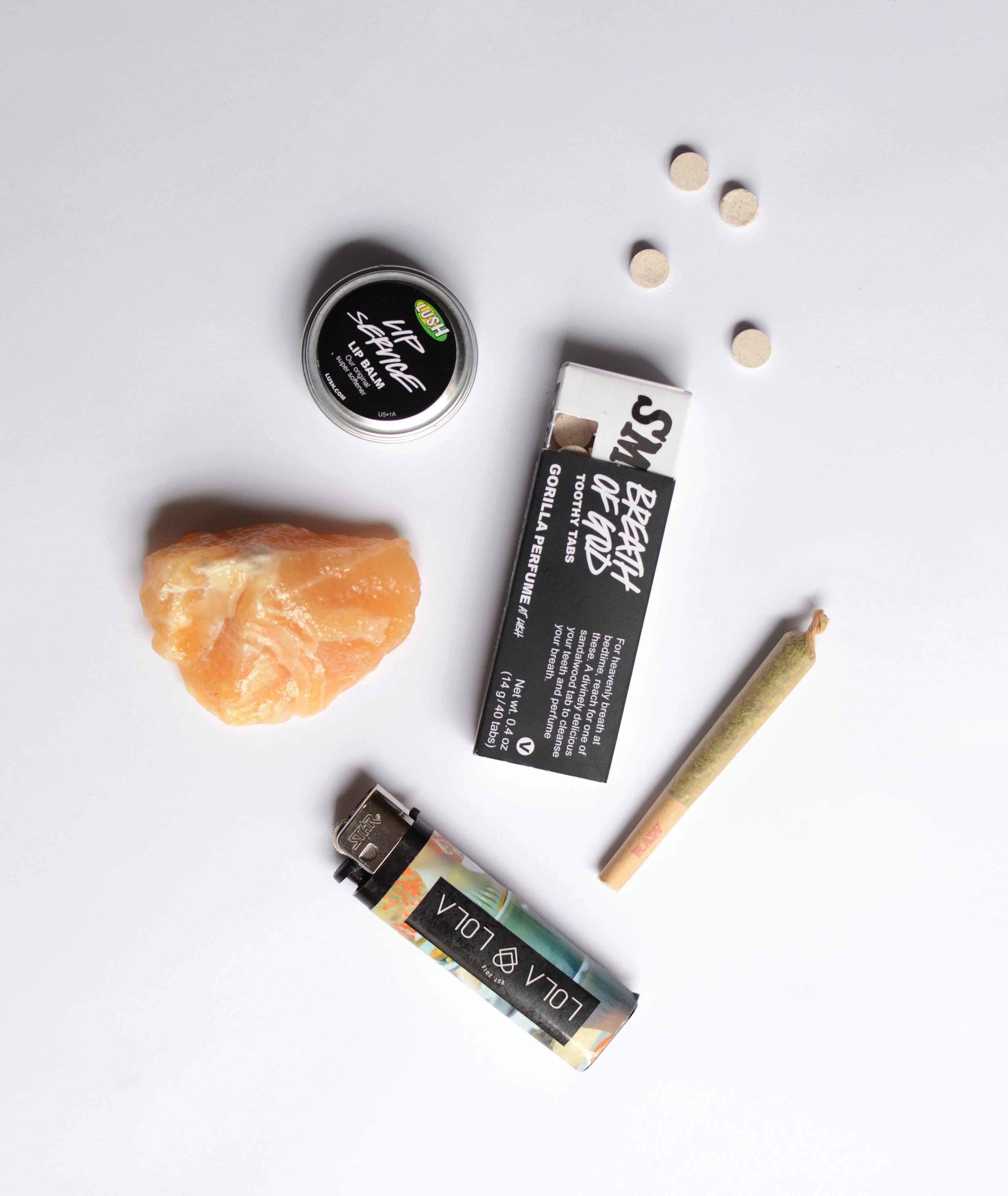 Lip Service lip balm by Lush Cosmetics (very moisturizing, and not too strong of an odor) / Breath of God Toothy Tabs by Lush Cosmetics / Strawberry Cough joint by Headquarters Dispensary (for keeping my own energy stable and free of anxiety) / Lola Lola lighter by Lola Lola / Citrine crystal from Sedona (for attracting only the people and things I need, and giving me the strength to turn away things that harm my energy - read more about its properties here ) 