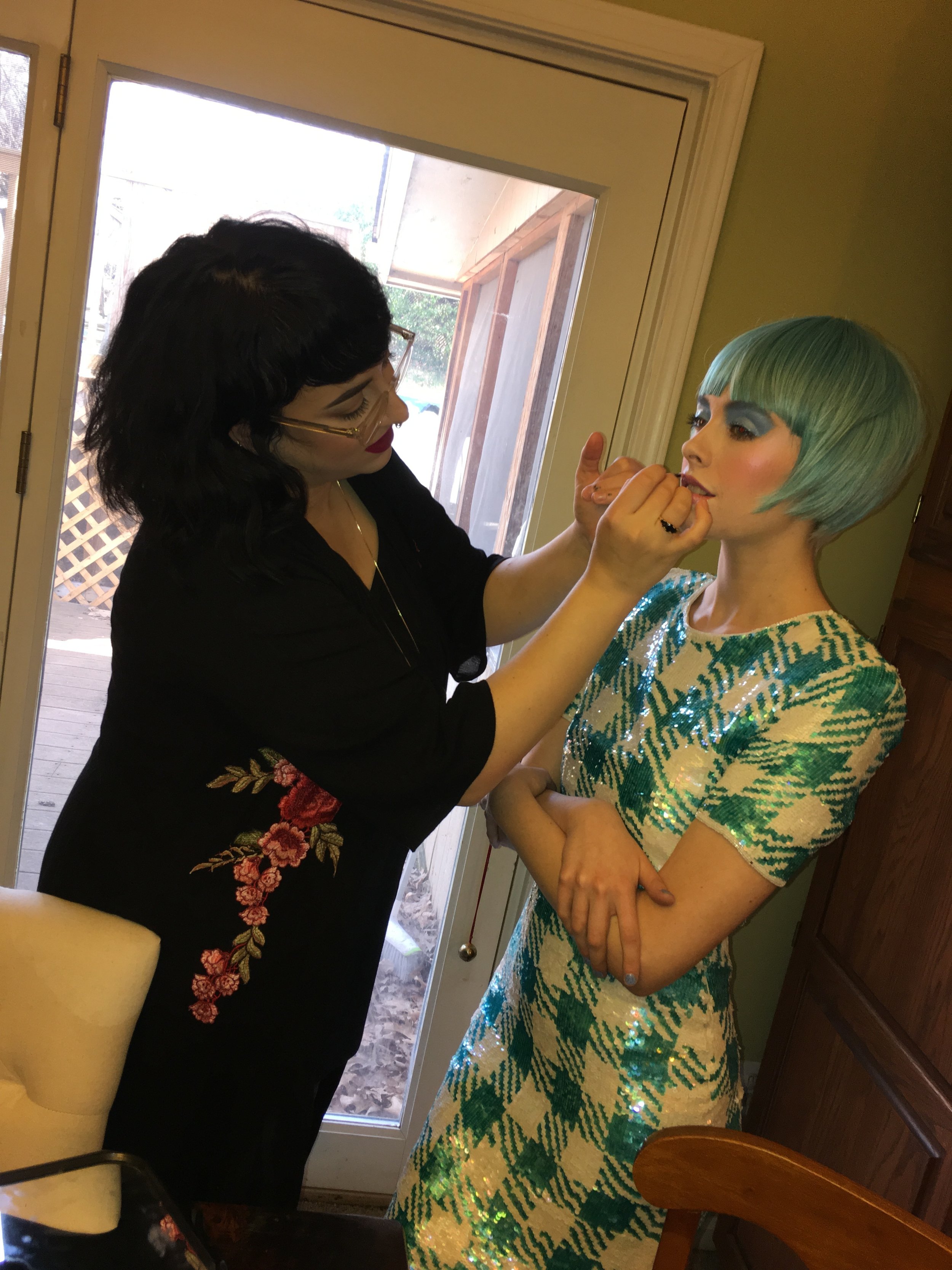 Becca touching up Alli's lipstick