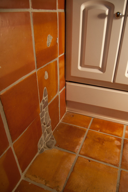 Terra cotta tile with pebble inlay