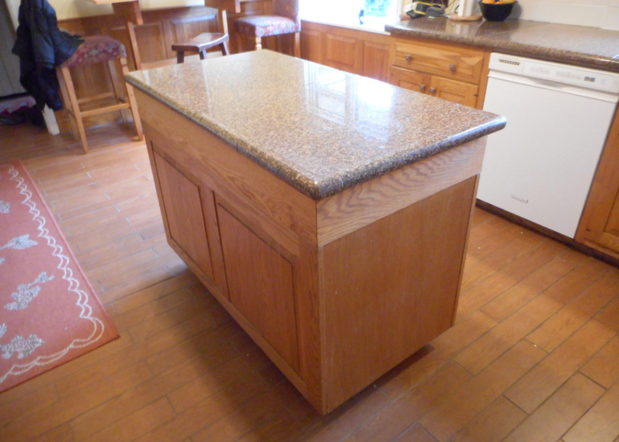 Granite tile countertop, ceramic plank floor