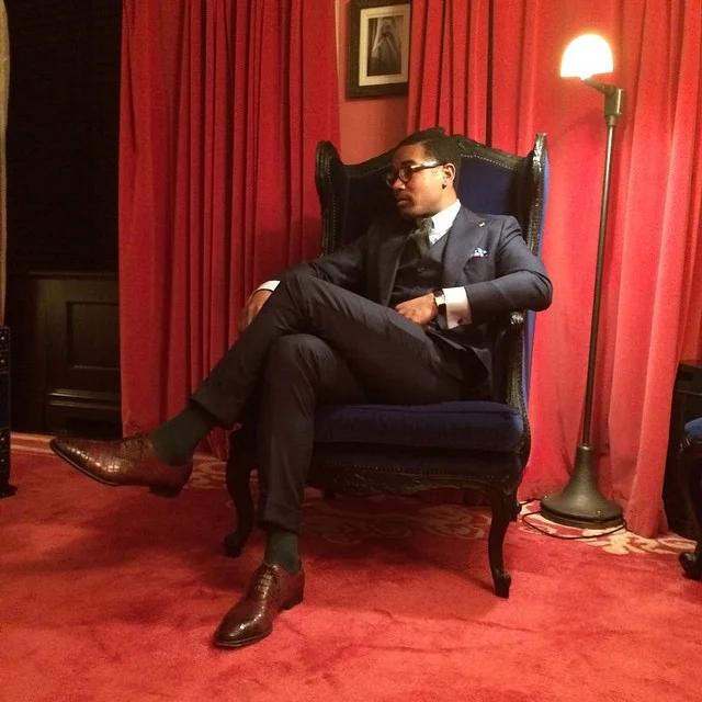 Three piece suit by A.M. Bespoke, shirt by Brioni, tie by Ike Behar, shoes by Brioni, socks by Bresciani, gold Fleur de lis by By Elias