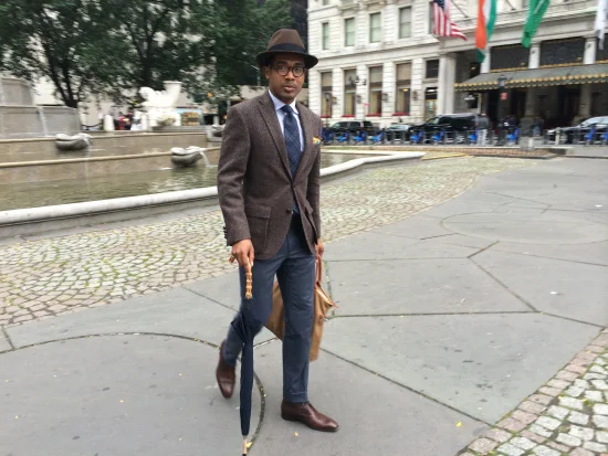 Brown Fedora by Selentino, Harris Tweed jacket by Bloomingdale's, Cashmere trousers by Brioni, Chukkas by Barney's, Umbrella by Kent Wang