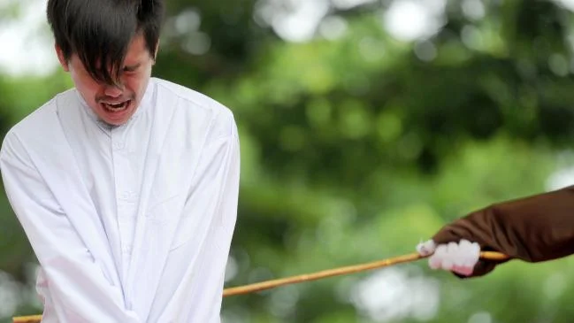 An Indonesian man is publicly caned for having sex in Banda Aceh. Picture: AFP